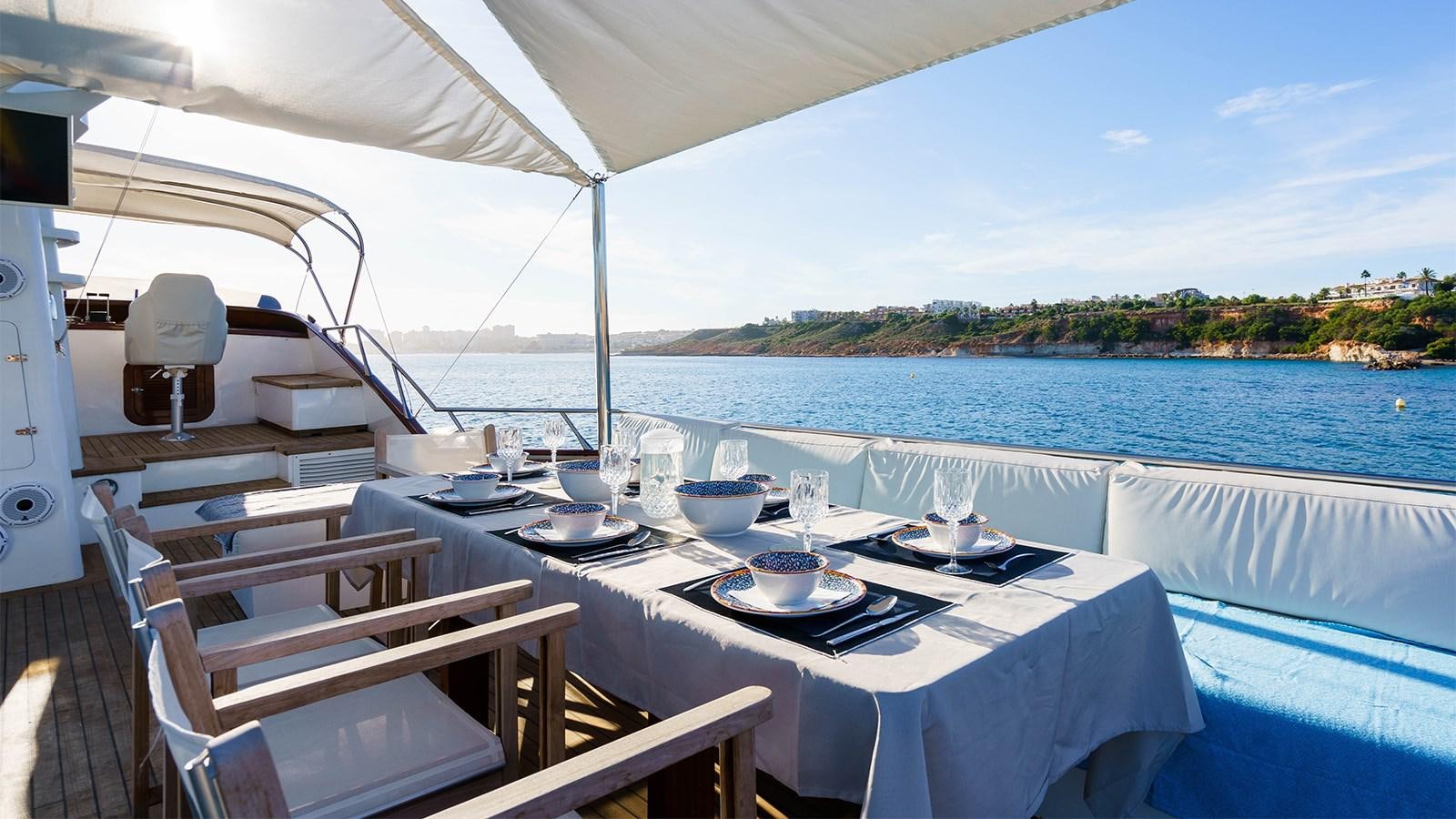 a table set for a meal on a boat aboard SPIRIT OF MK Yacht for Sale