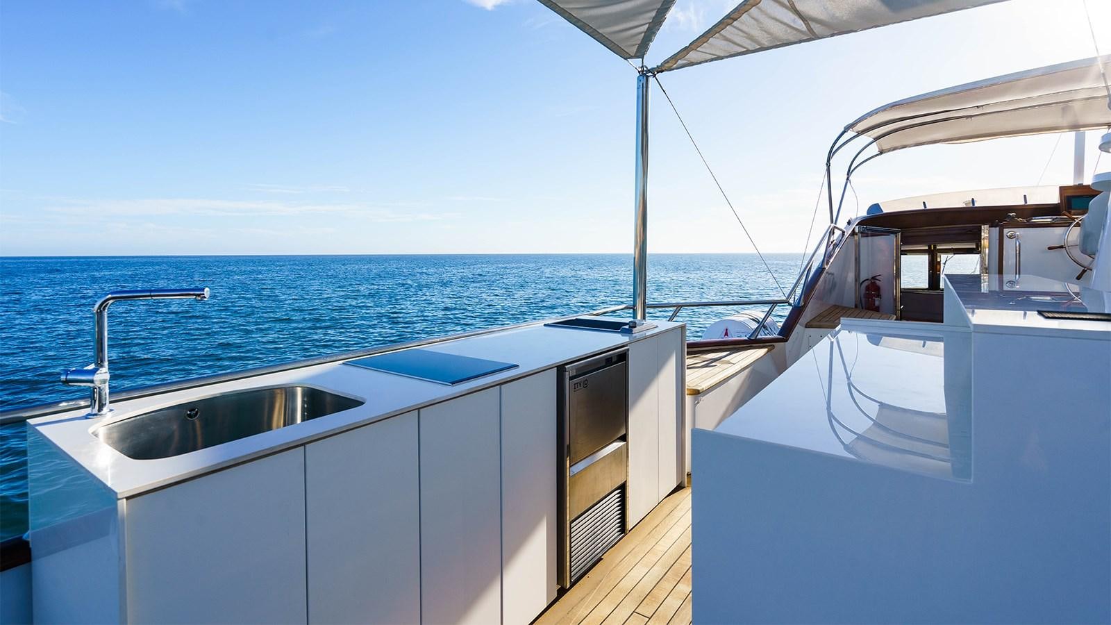 a boat with a sink and a large body of water in the background aboard SPIRIT OF MK Yacht for Charter