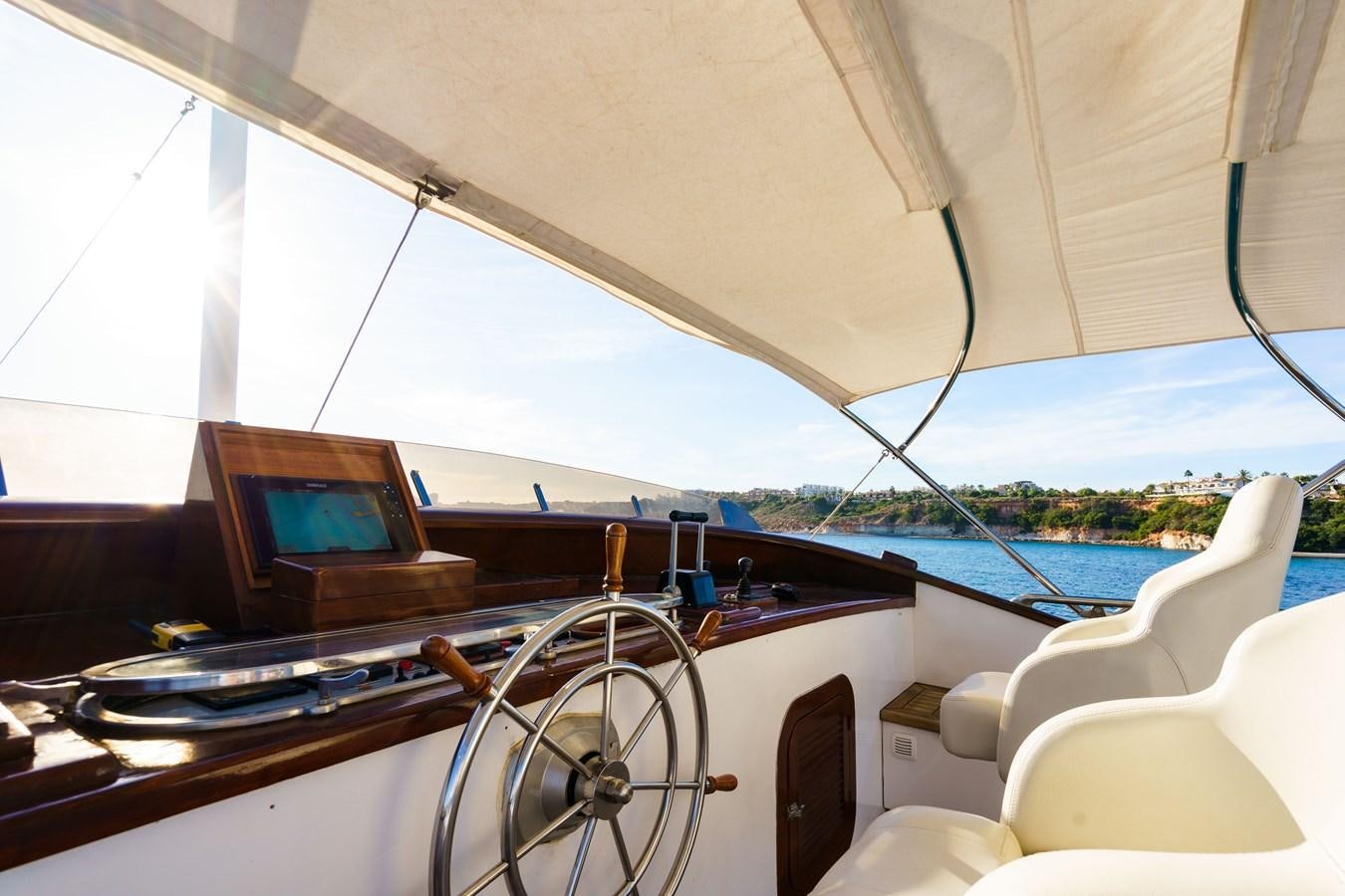 inside of a tent with a table and chairs and a laptop on a table with a view of aboard SPIRIT OF MK Yacht for Sale