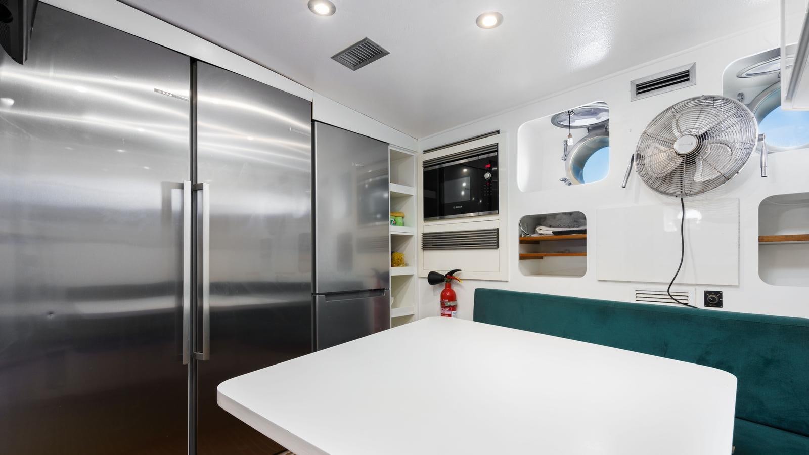 a large kitchen with a large refrigerator aboard SPIRIT OF MK Yacht for Sale