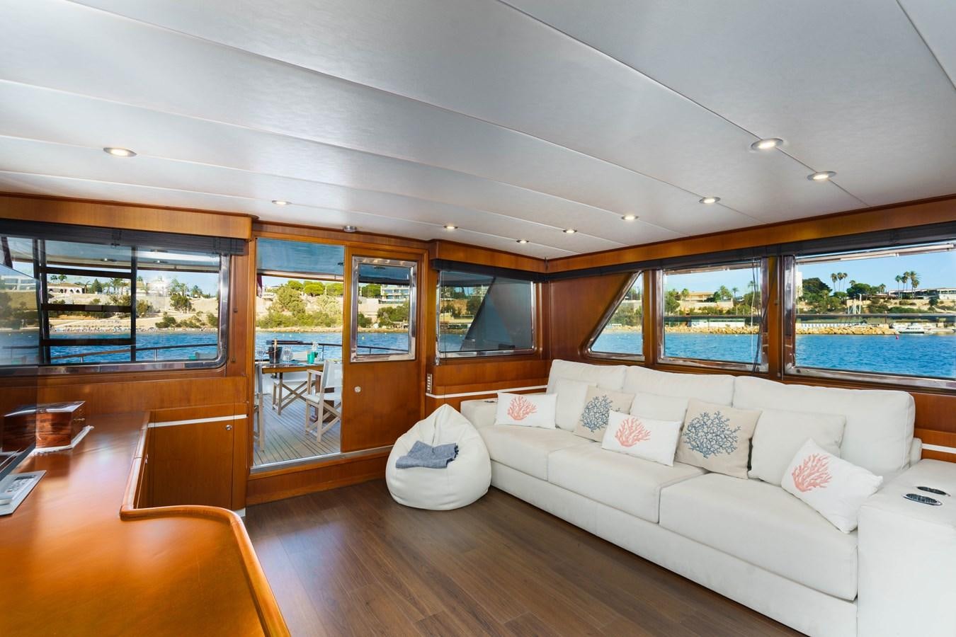 a living room with a large window aboard SPIRIT OF MK Yacht for Sale