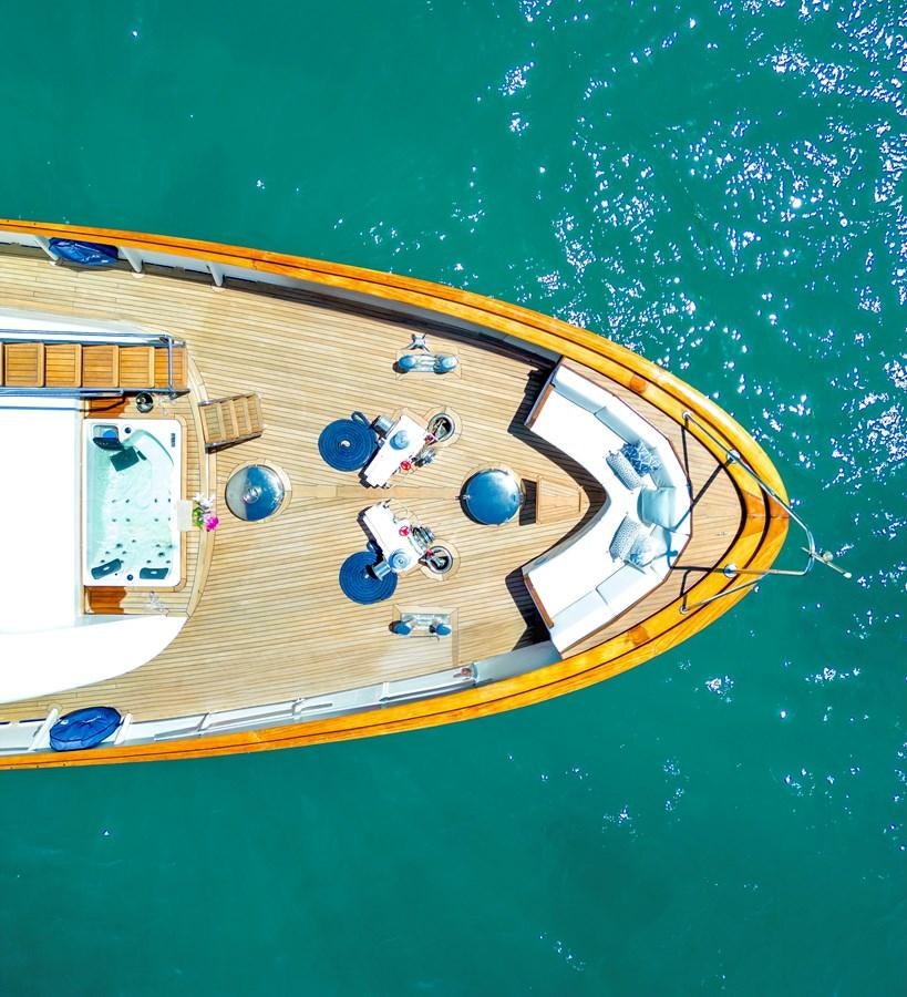a yellow boat with blue water and a white circle on it aboard SPIRIT OF MK Yacht for Sale