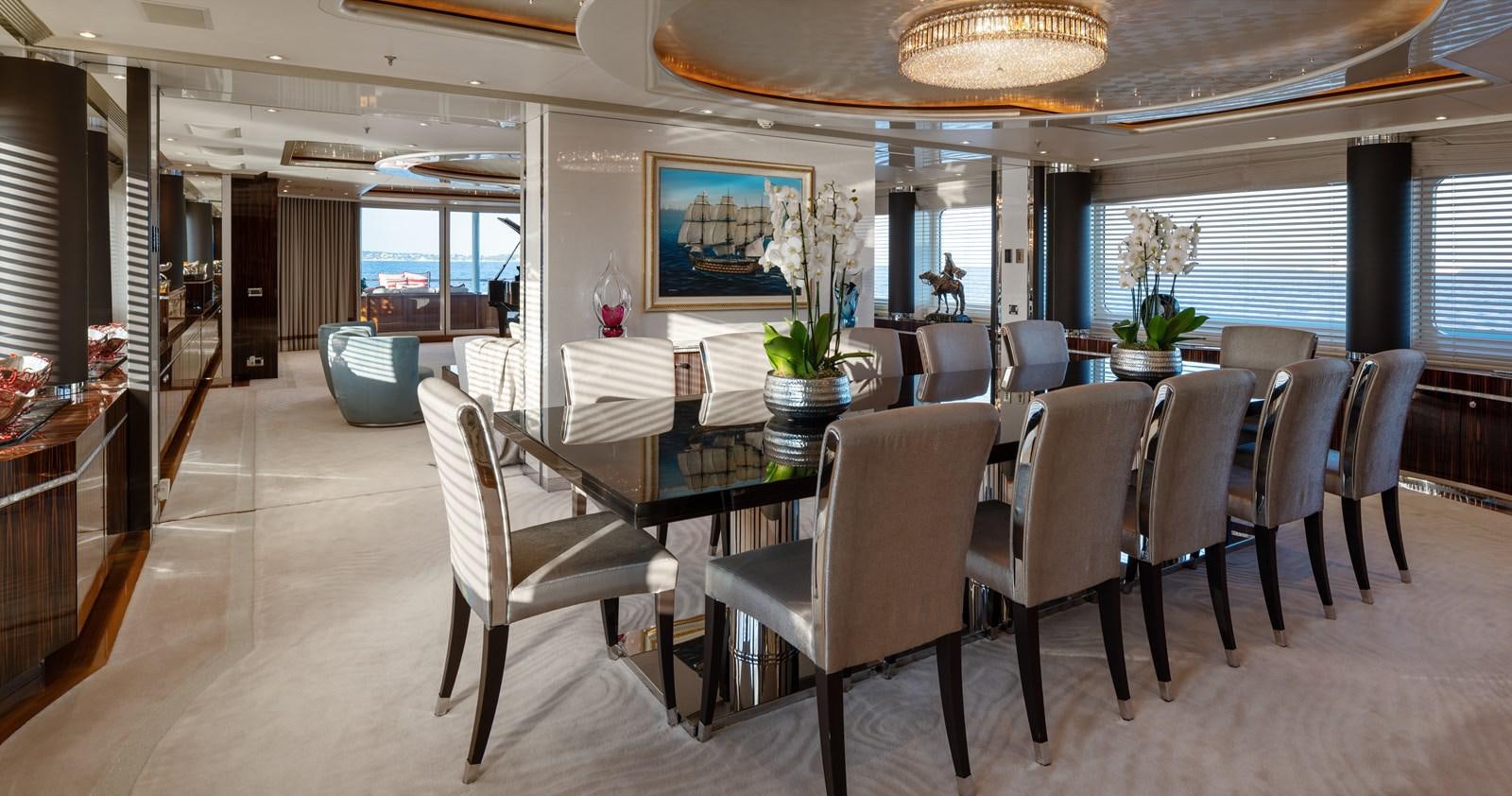 a large room with tables and chairs aboard ALFA G Yacht for Sale