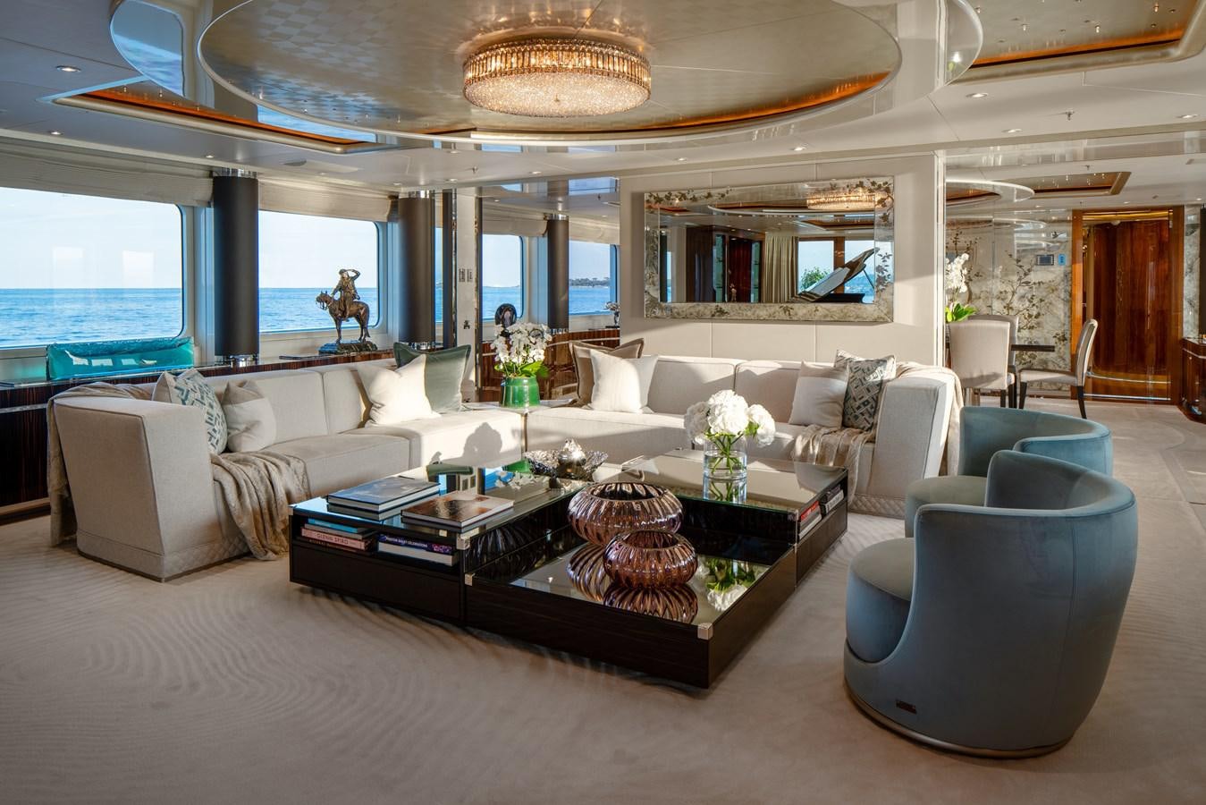 a living room with a large chandelier aboard ALFA G Yacht for Sale
