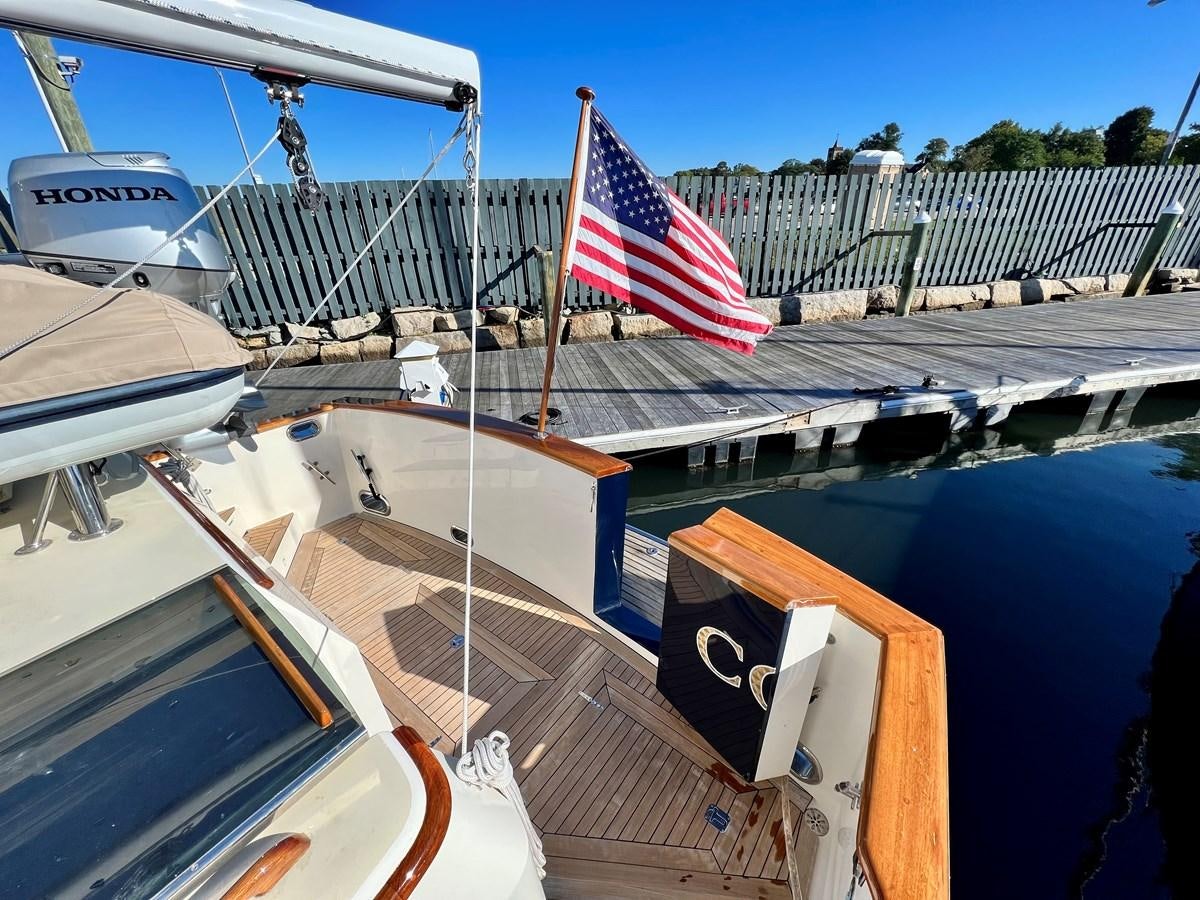 a boat with a flag on the front aboard COTYTTO Yacht for Sale