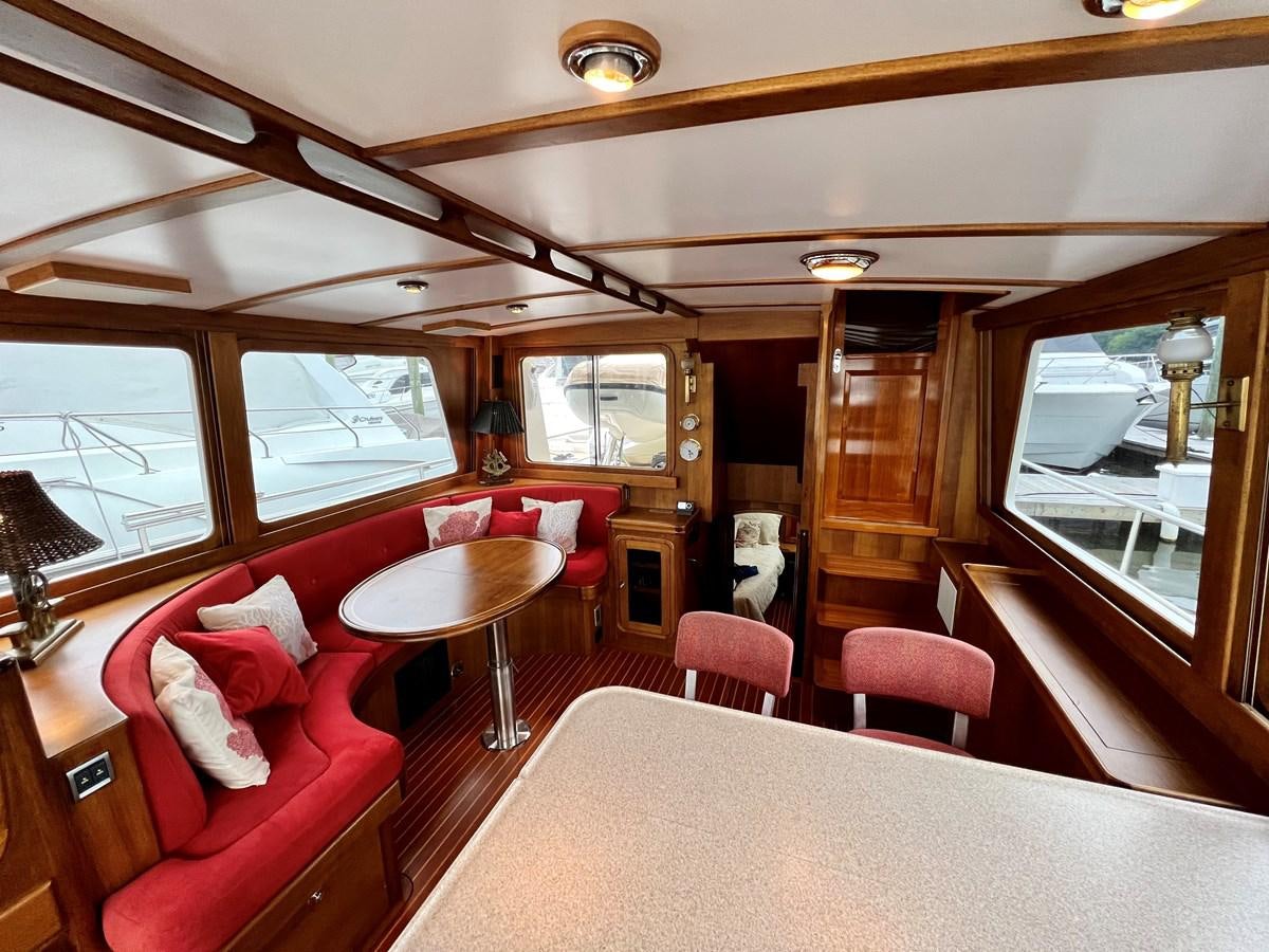 a train car with a table and chairs aboard COTYTTO Yacht for Sale
