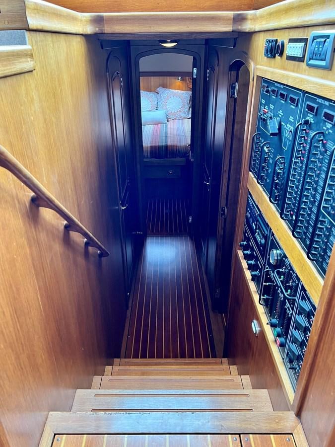a hallway with a wood door aboard COTYTTO Yacht for Sale