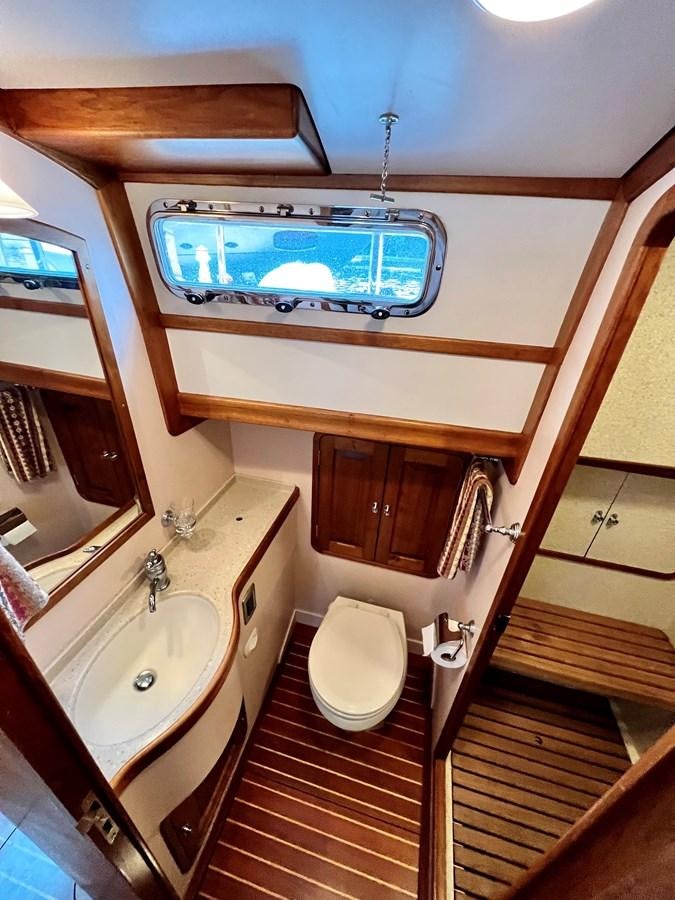 a bathroom with a wood floor aboard COTYTTO Yacht for Sale