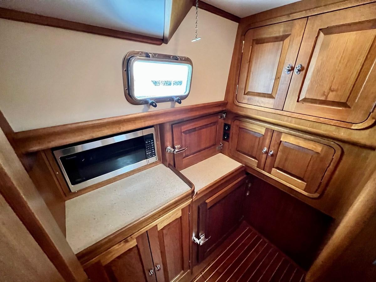 a tv on a wooden cabinet aboard COTYTTO Yacht for Sale