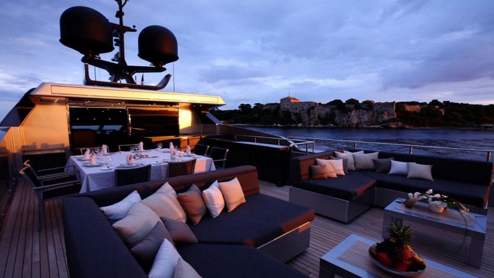 a deck with a large patio and a large body of water aboard NAIA Yacht for Sale