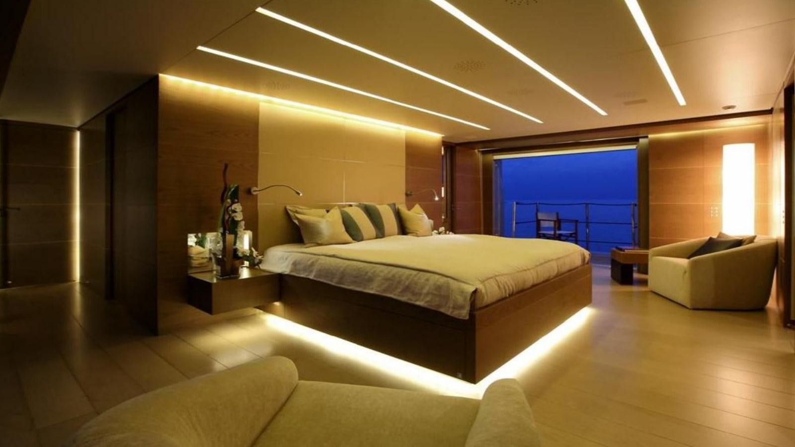 a room with a bed and a couch aboard NAIA Yacht for Sale