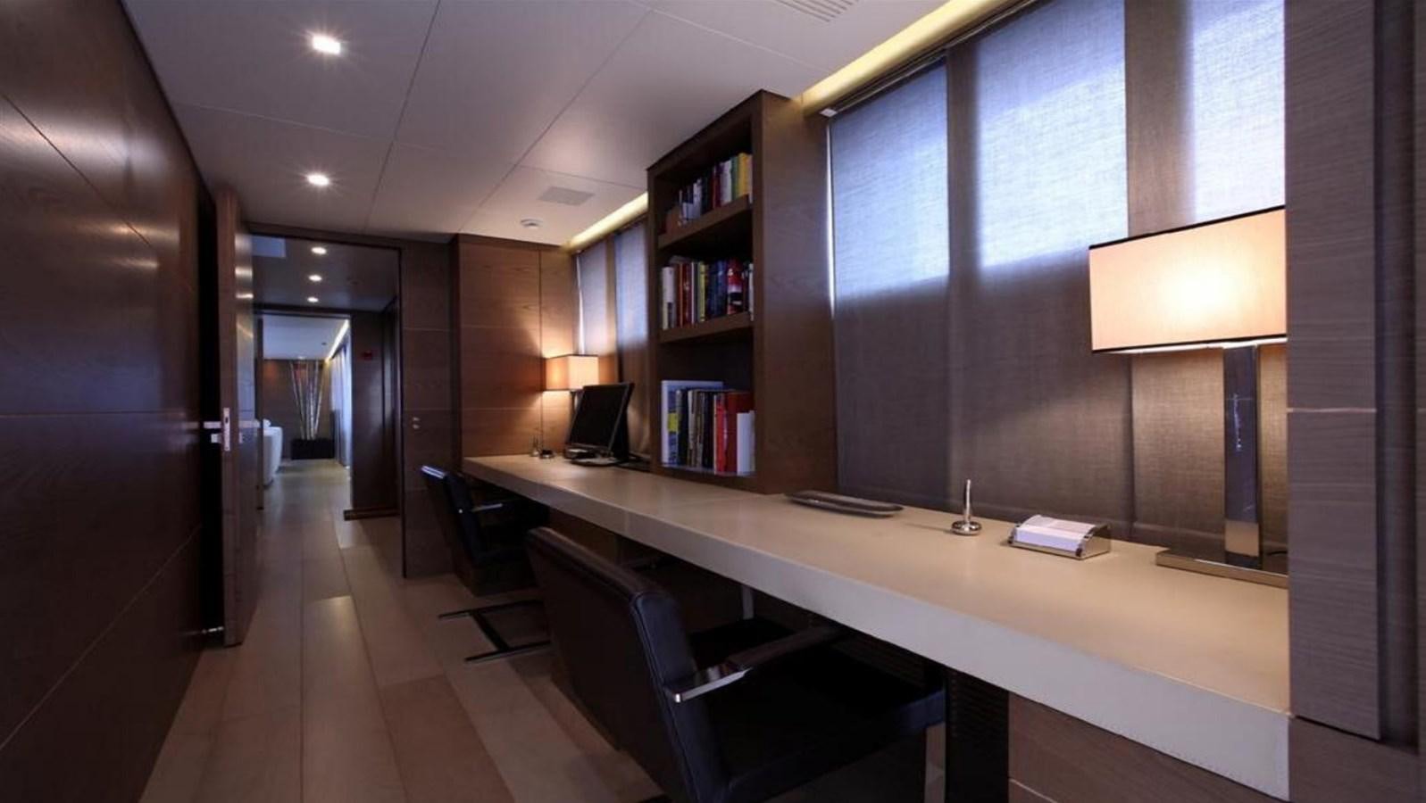 a room with a desk and a computer aboard NAIA Yacht for Sale