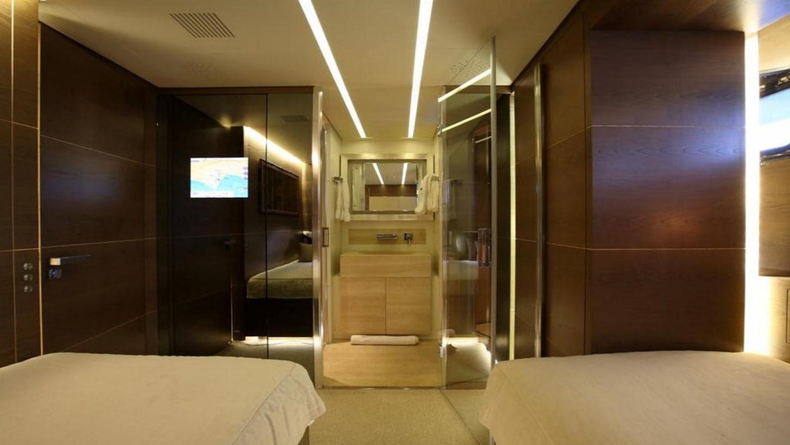 a room with a bed and a tv aboard NAIA Yacht for Sale
