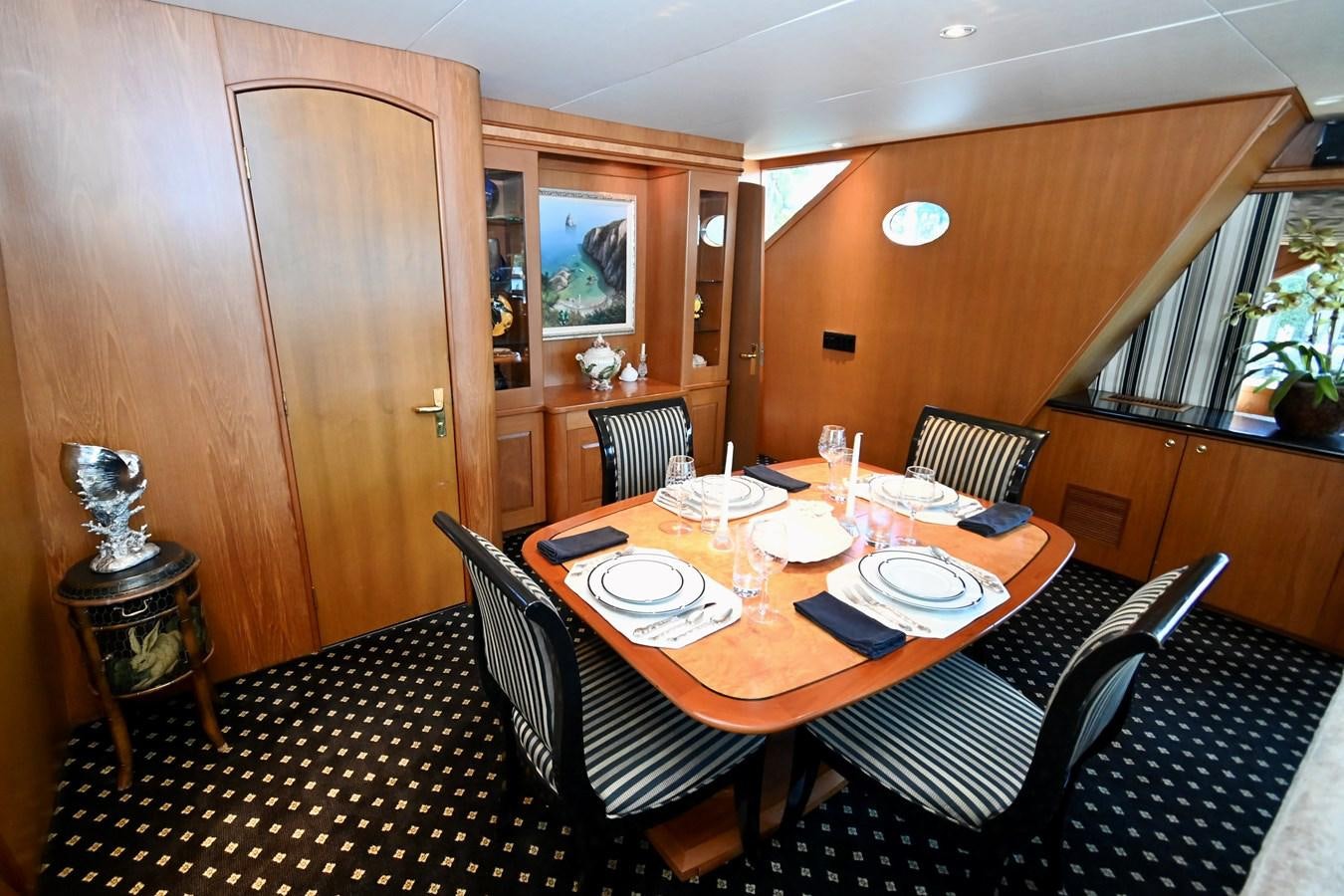 a dining table and chairs aboard CAPTIVATOR Yacht for Sale