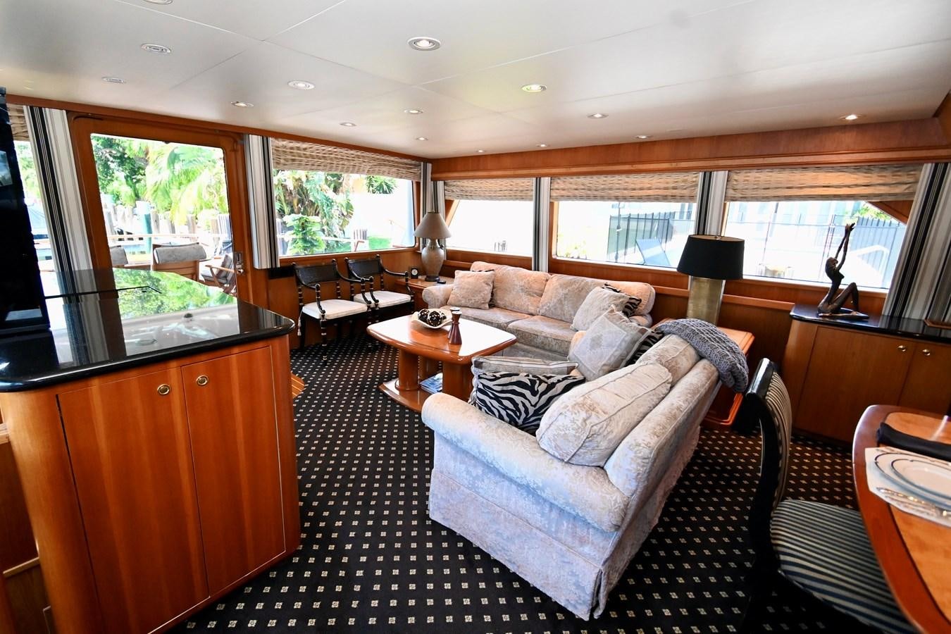 a living room with a large window aboard CAPTIVATOR Yacht for Sale