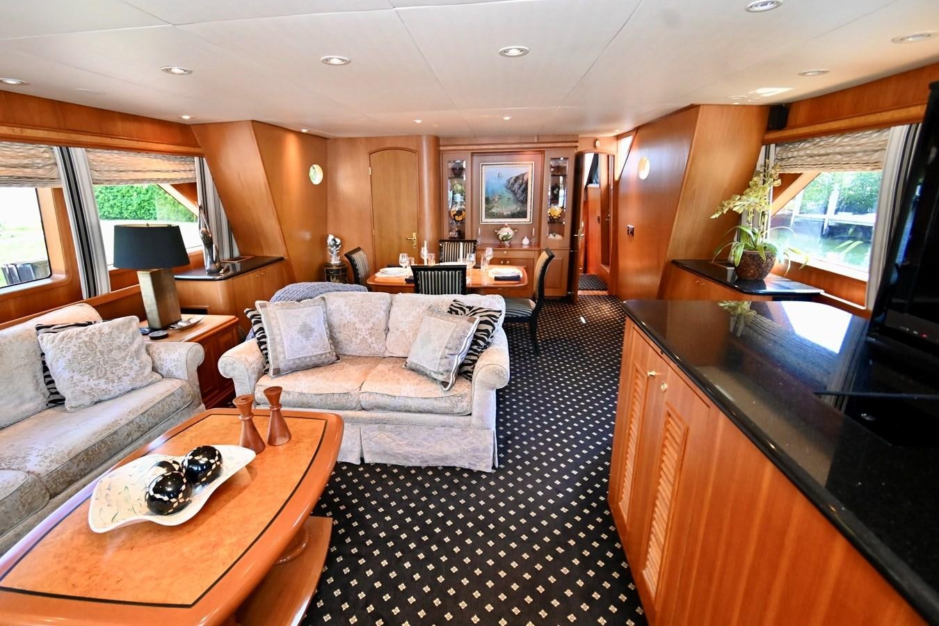 a living room with a couch and a table aboard CAPTIVATOR Yacht for Sale