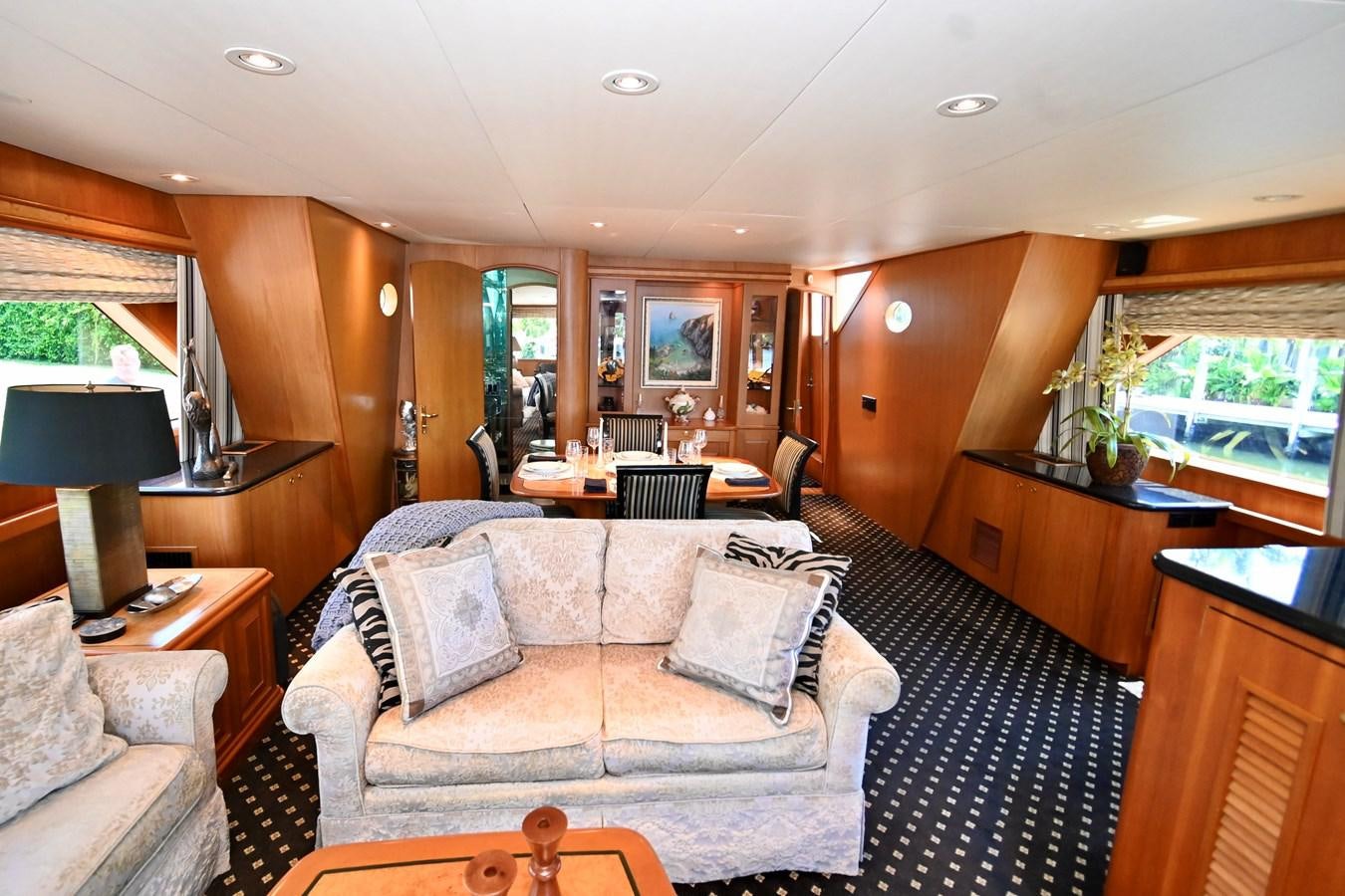 a living room with a couch and a television aboard CAPTIVATOR Yacht for Sale