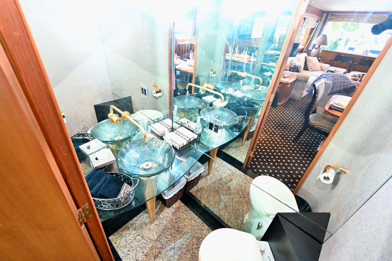 a bathroom with a tub sink and toilet aboard CAPTIVATOR Yacht for Sale