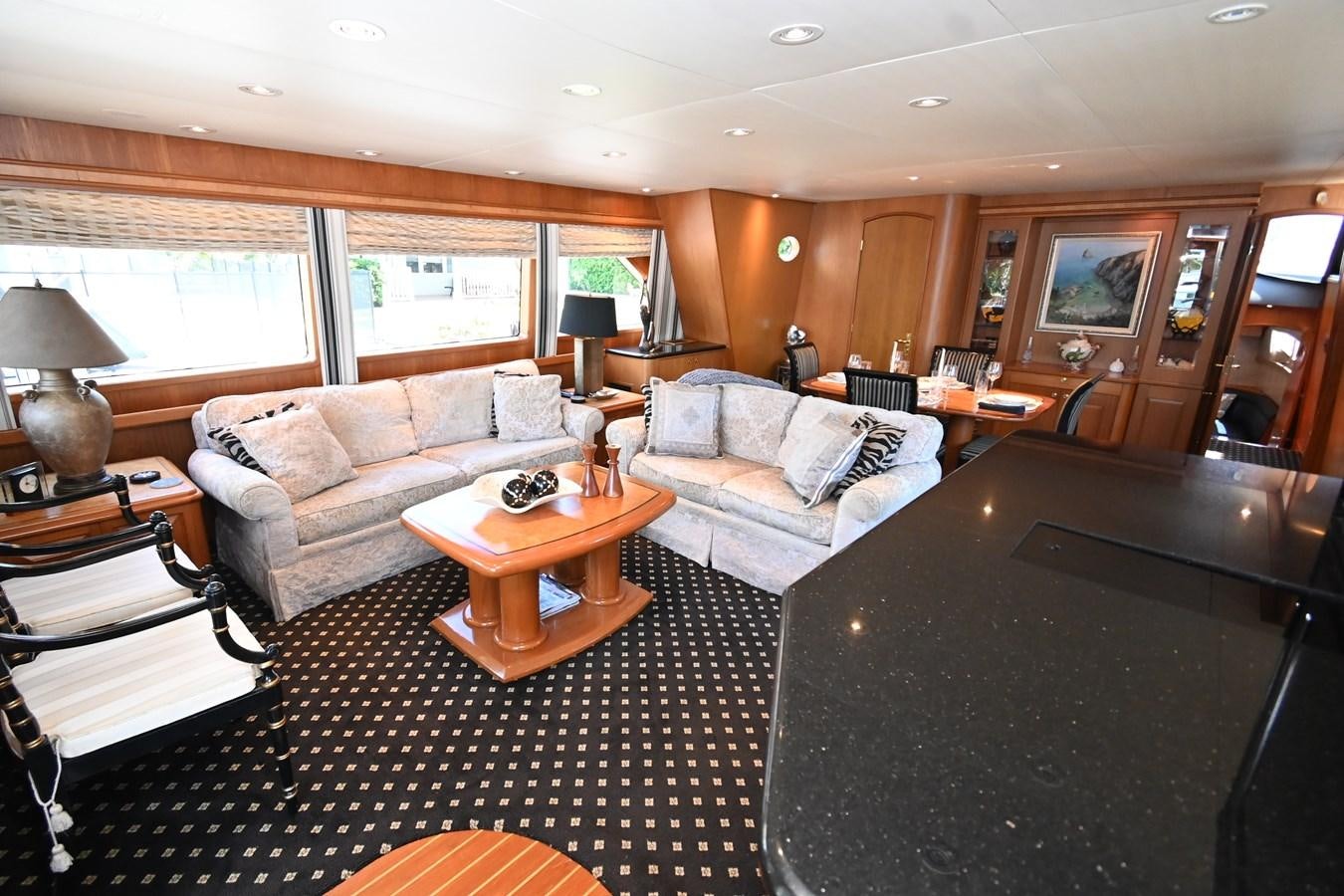 a living room with a couch and a coffee table aboard CAPTIVATOR Yacht for Sale