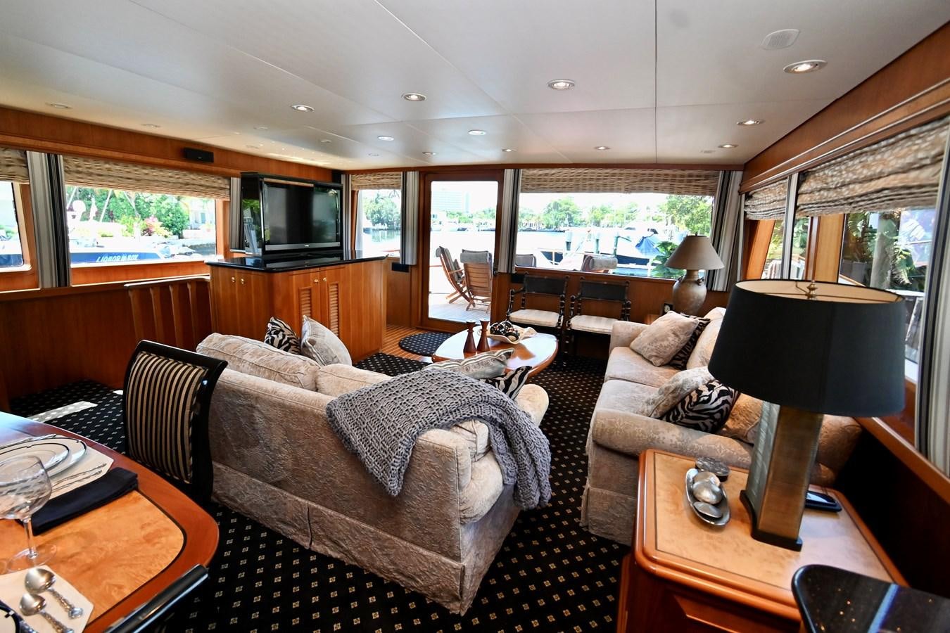 a living room with a couch and a lamp aboard CAPTIVATOR Yacht for Sale