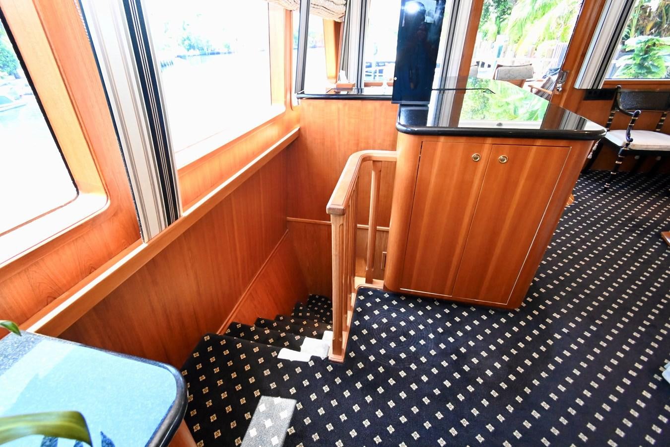 a room with a table and chairs aboard CAPTIVATOR Yacht for Sale