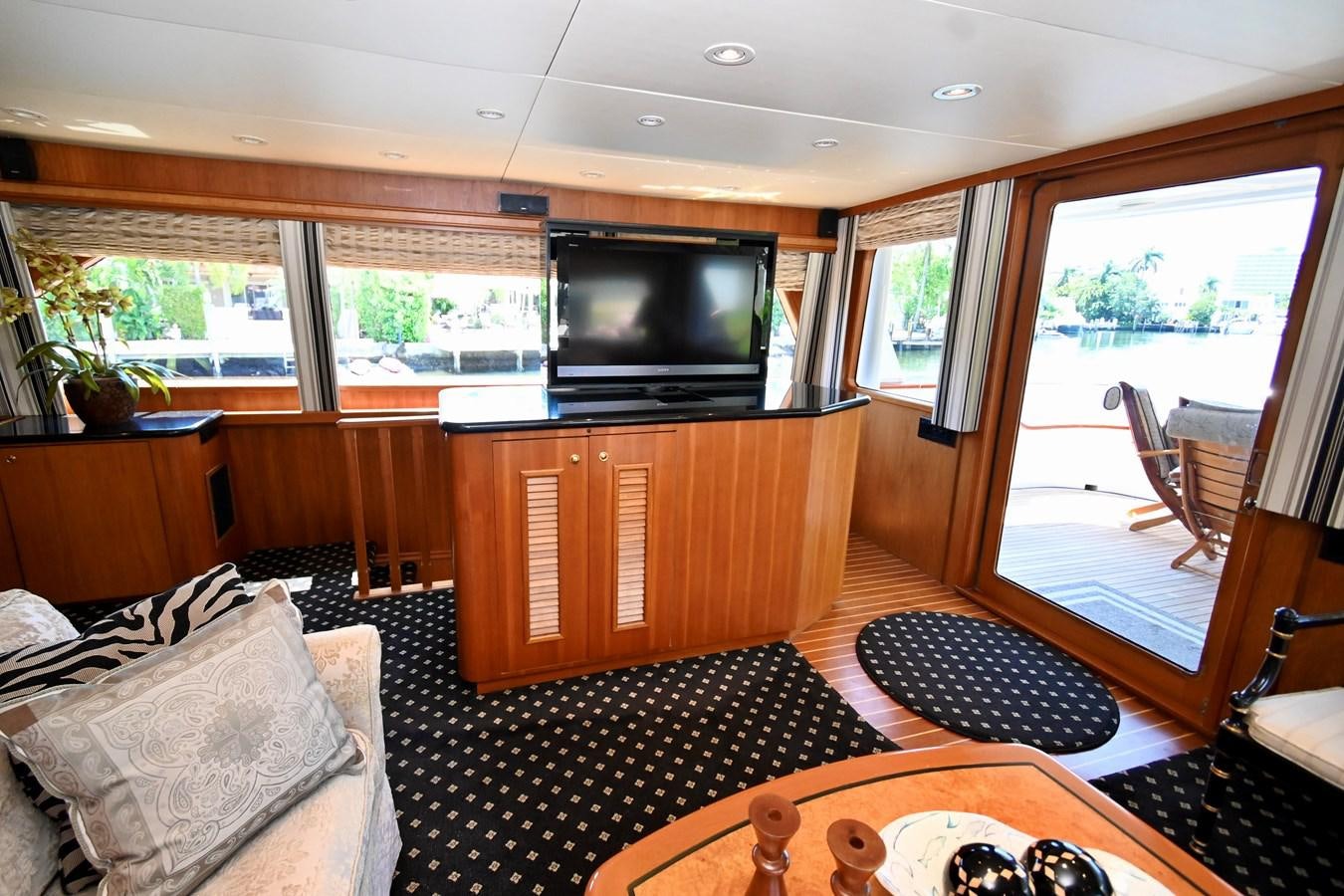 a living room with a tv and a fireplace aboard CAPTIVATOR Yacht for Sale