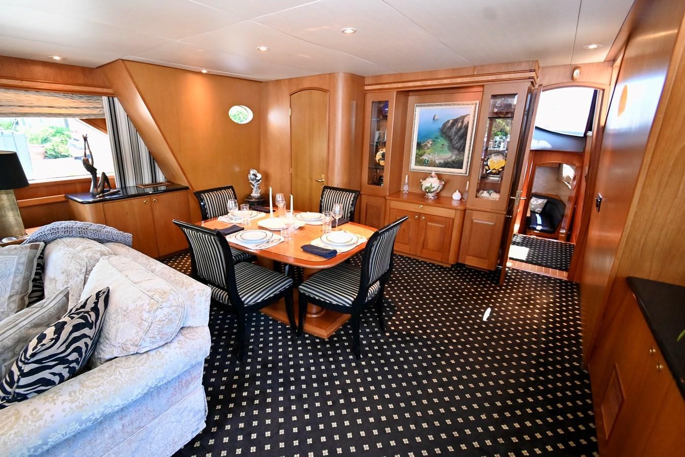 a dining room with couches aboard CAPTIVATOR Yacht for Sale
