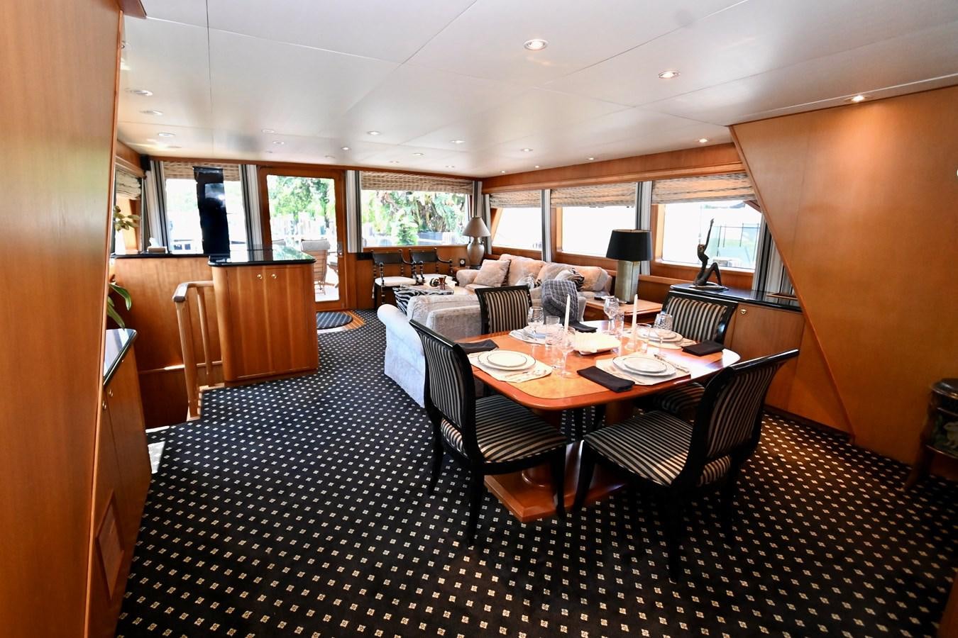 a dining room with chairs and a table aboard CAPTIVATOR Yacht for Sale