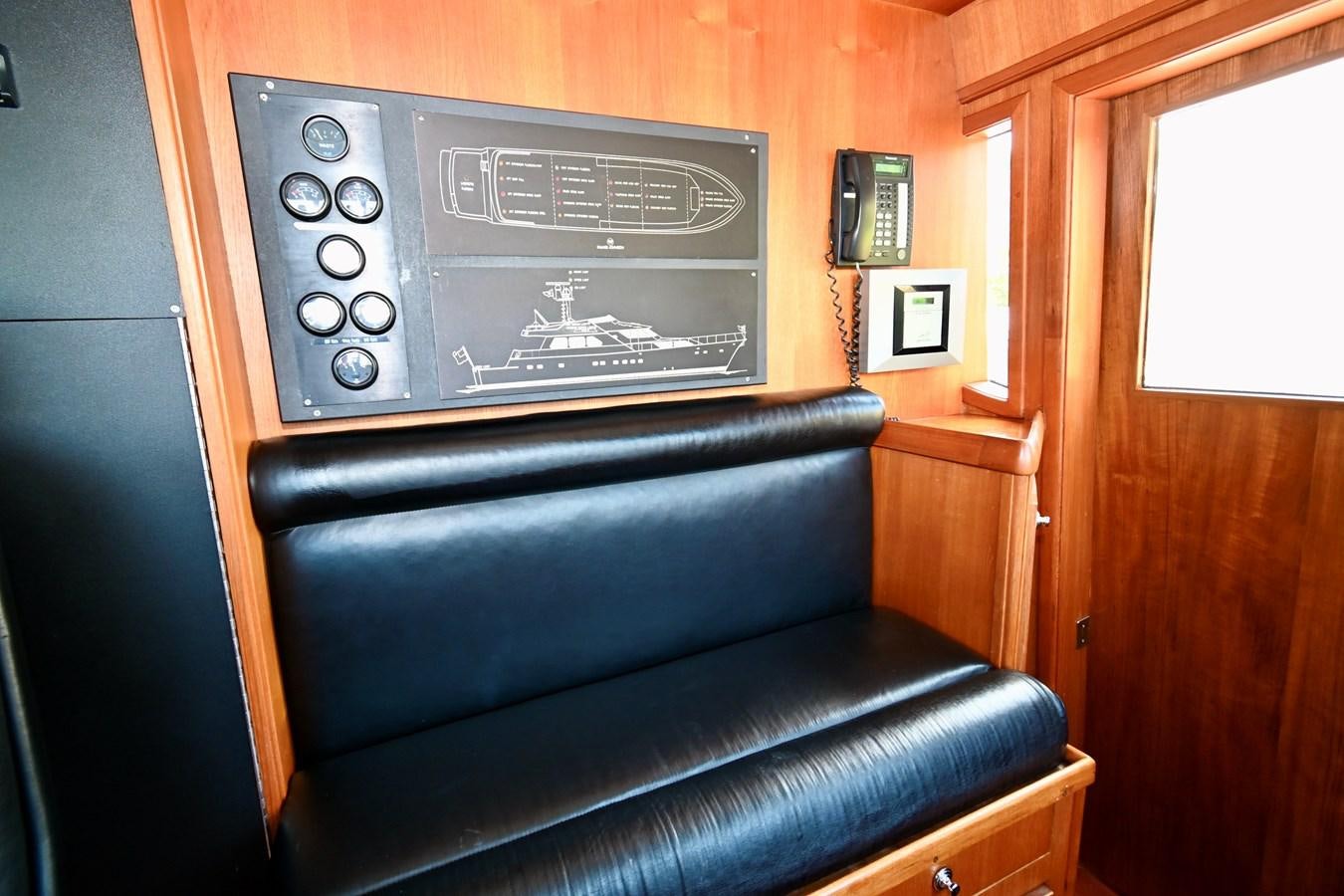 a black couch in a room aboard CAPTIVATOR Yacht for Sale
