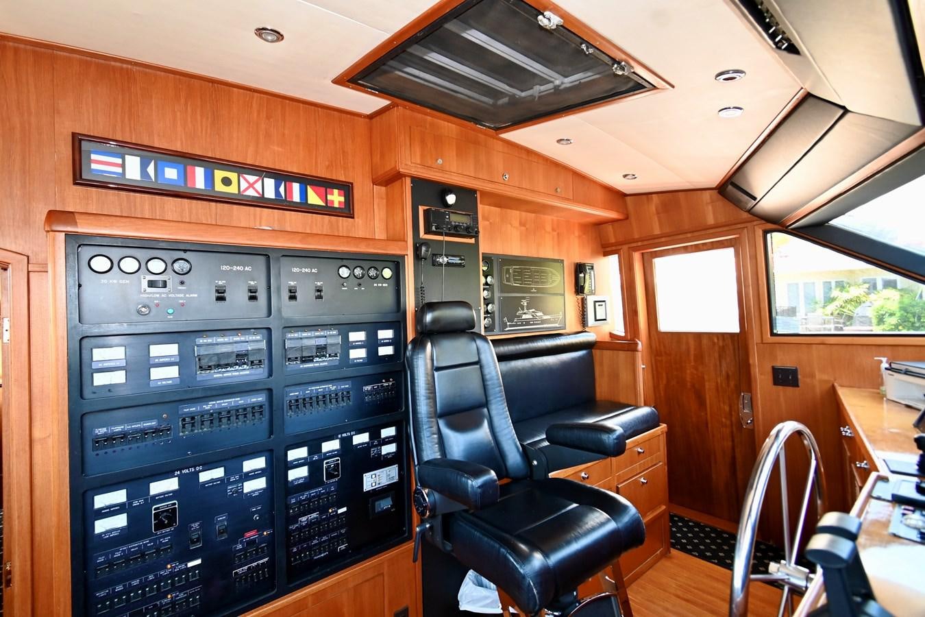 a room with a machine and chairs aboard CAPTIVATOR Yacht for Sale