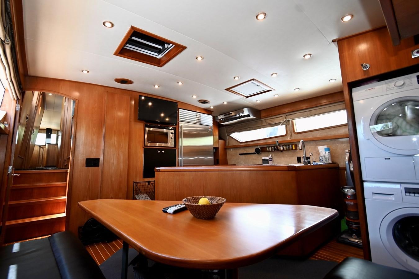 a kitchen with wooden cabinets aboard CAPTIVATOR Yacht for Sale