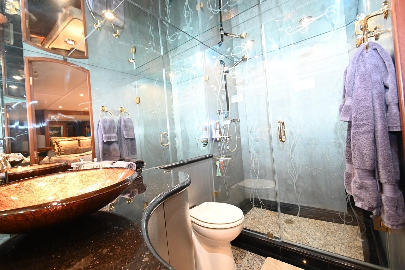 a bathroom with a sink toilet and a bathtub aboard CAPTIVATOR Yacht for Sale