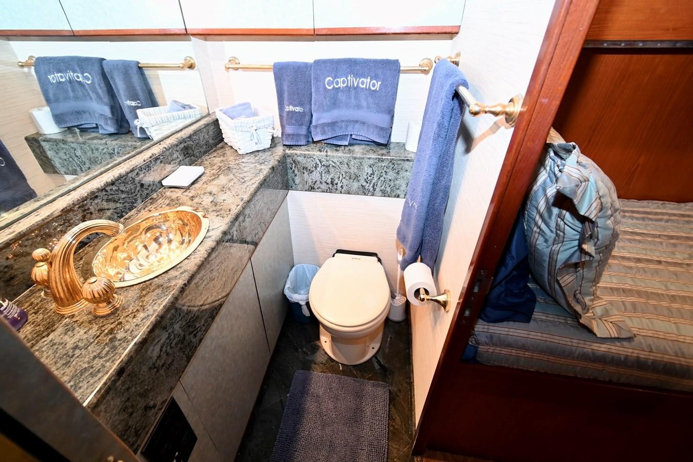a bathroom with a sink and toilet aboard CAPTIVATOR Yacht for Sale