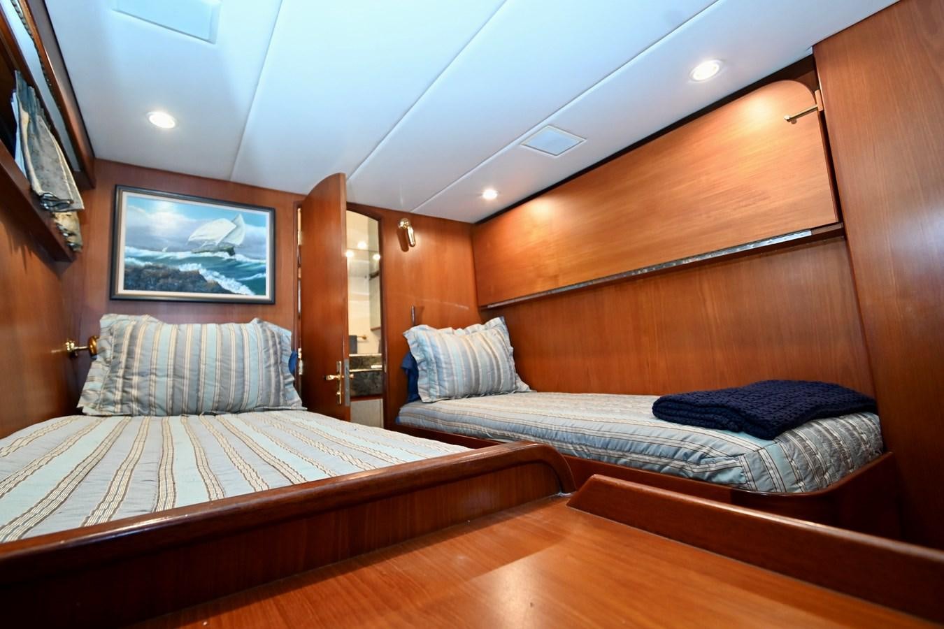 a room with two beds aboard CAPTIVATOR Yacht for Sale