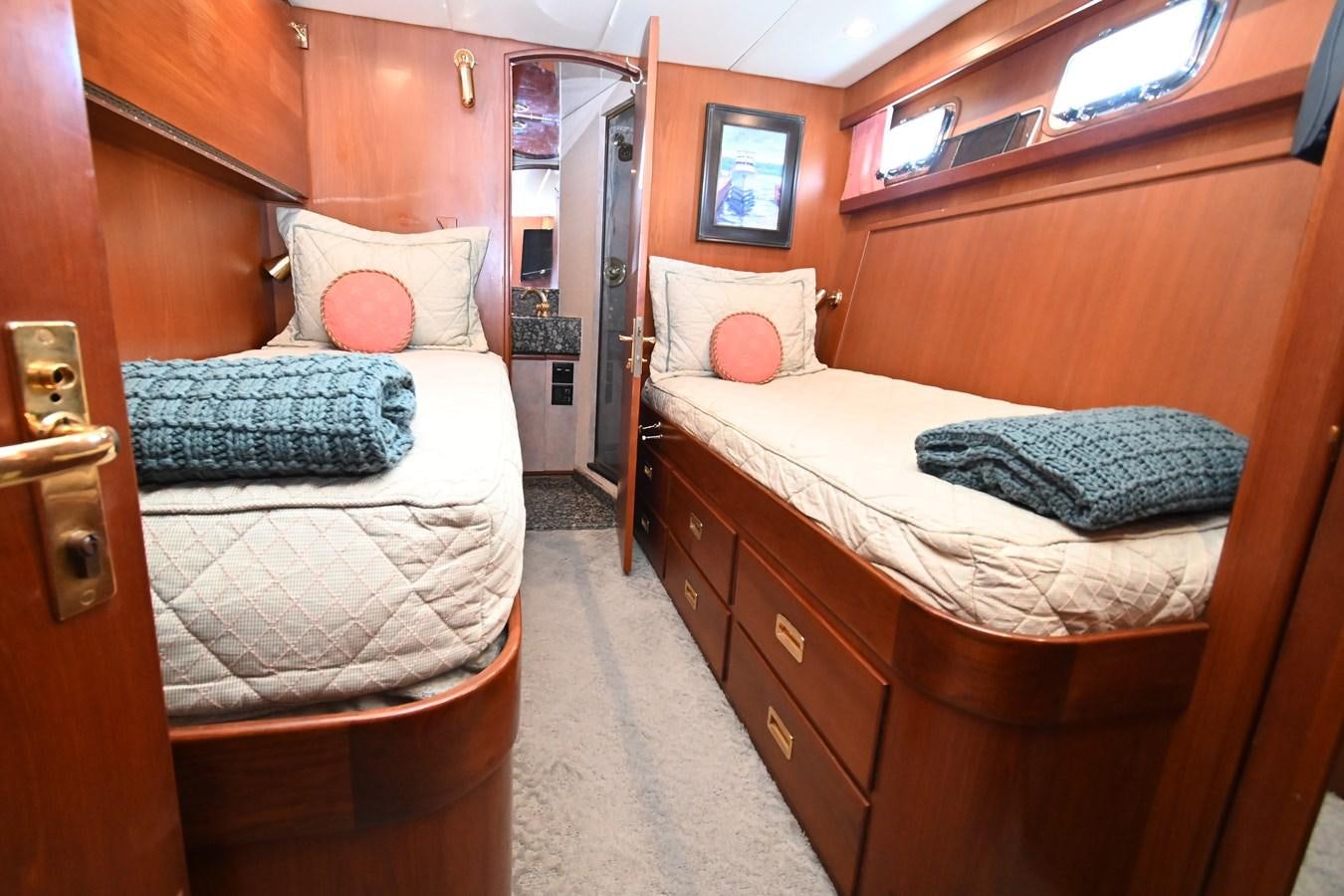 a couple of beds in a room aboard CAPTIVATOR Yacht for Sale