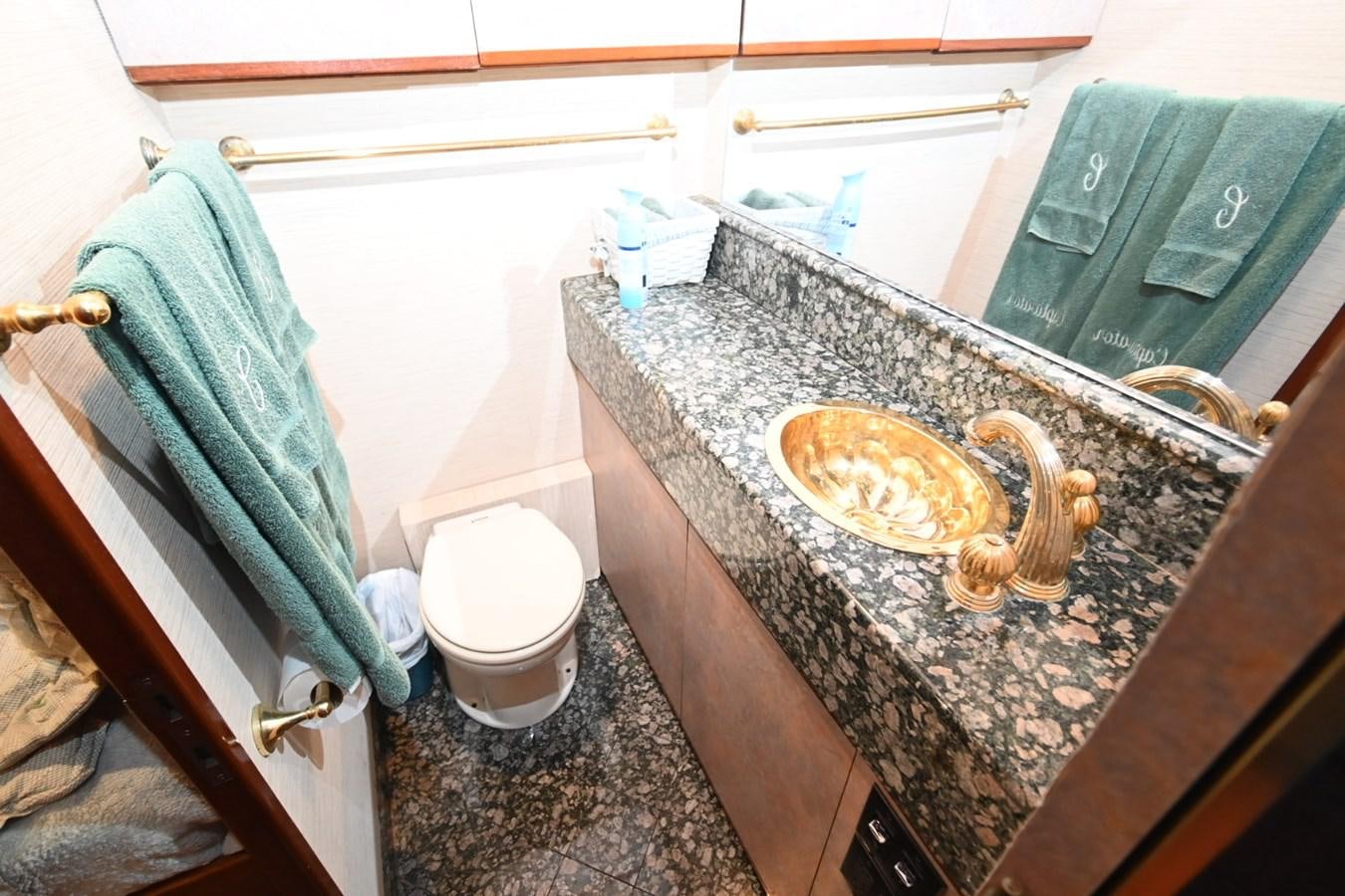 a bathroom with a marble counter top aboard CAPTIVATOR Yacht for Sale
