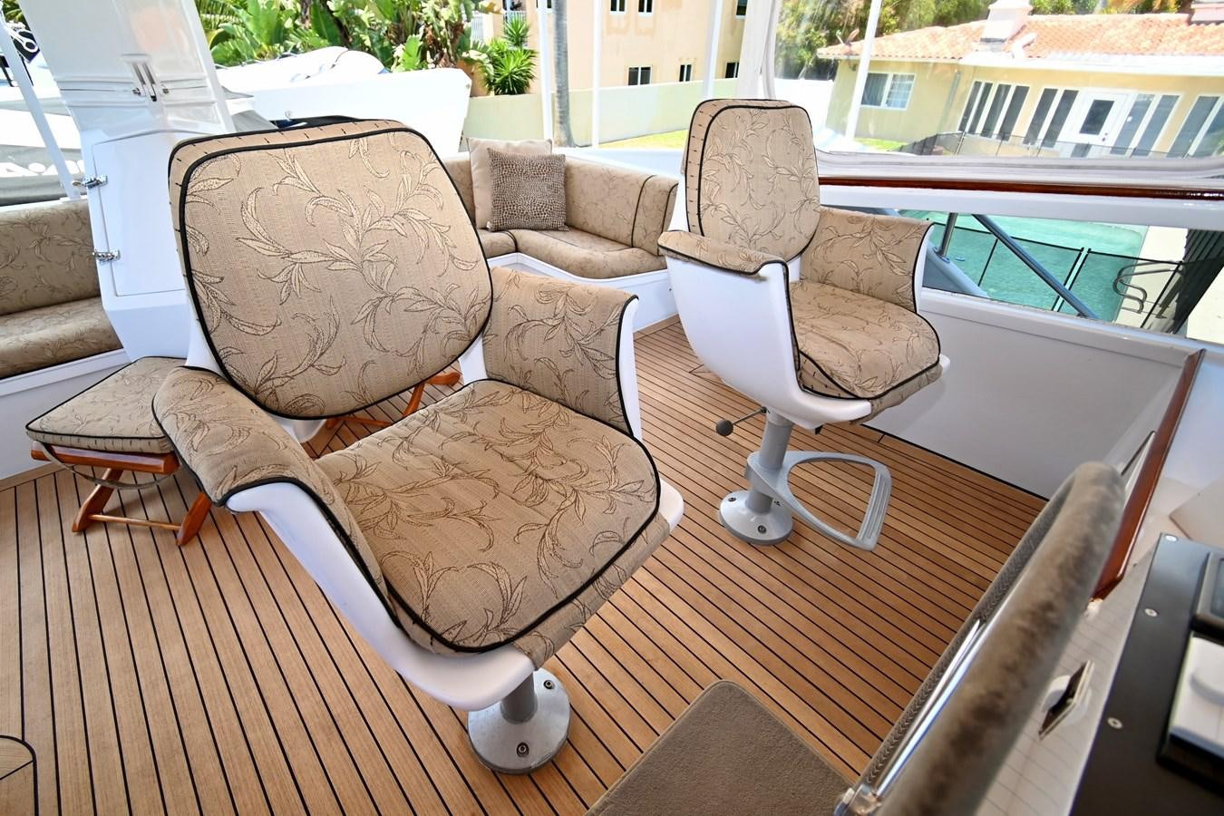 a couple of chairs by a pool aboard CAPTIVATOR Yacht for Sale