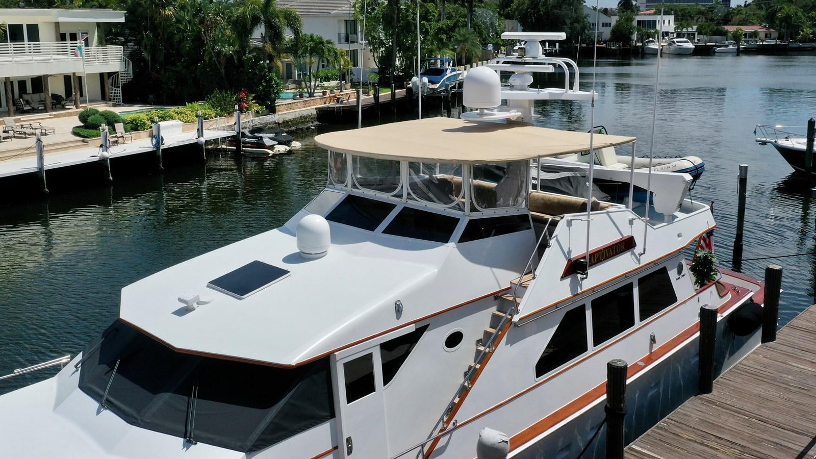 a boat in a harbor aboard CAPTIVATOR Yacht for Sale