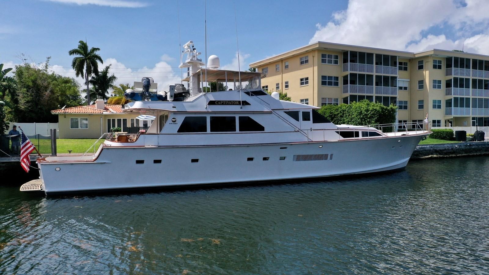 a large white boat in the water aboard CAPTIVATOR Yacht for Sale