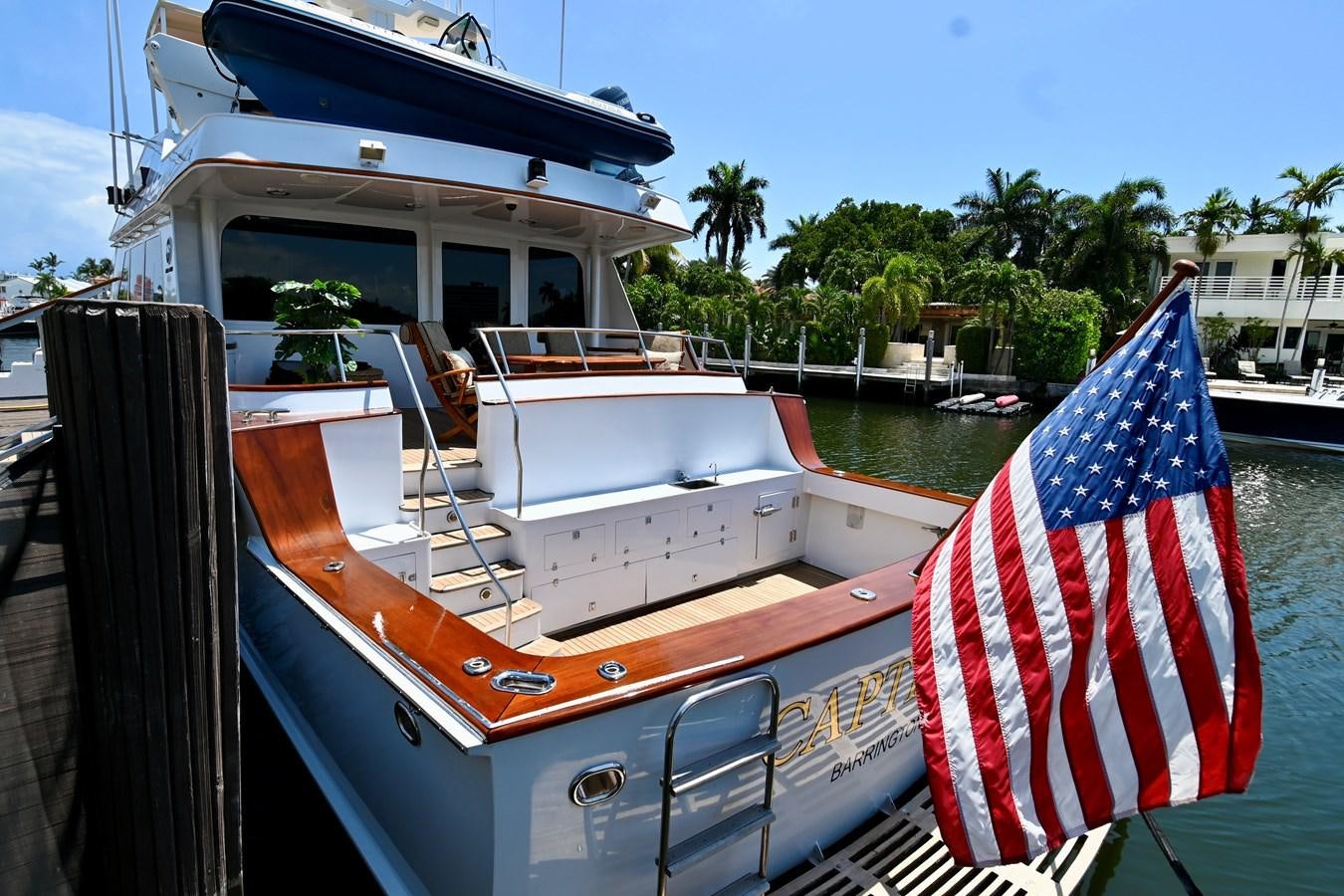 a boat with a flag on the front aboard CAPTIVATOR Yacht for Sale