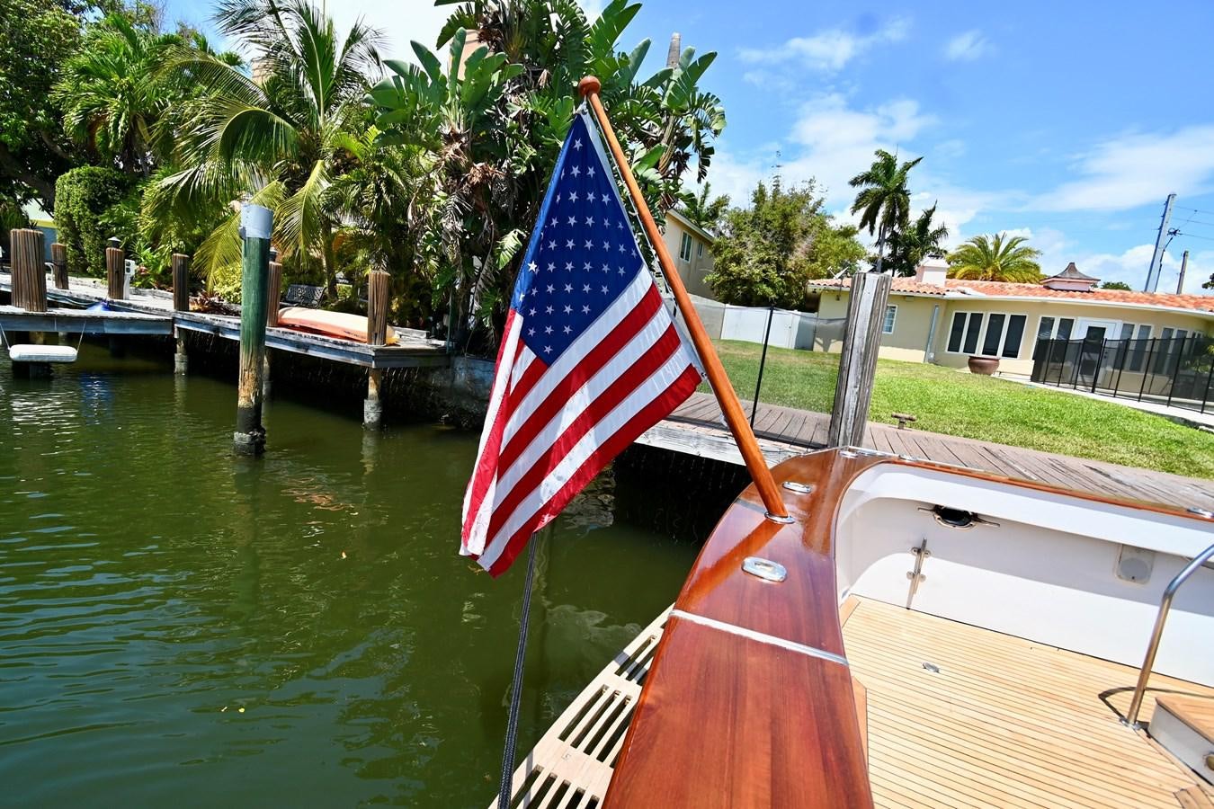 a boat with a flag on it aboard CAPTIVATOR Yacht for Sale