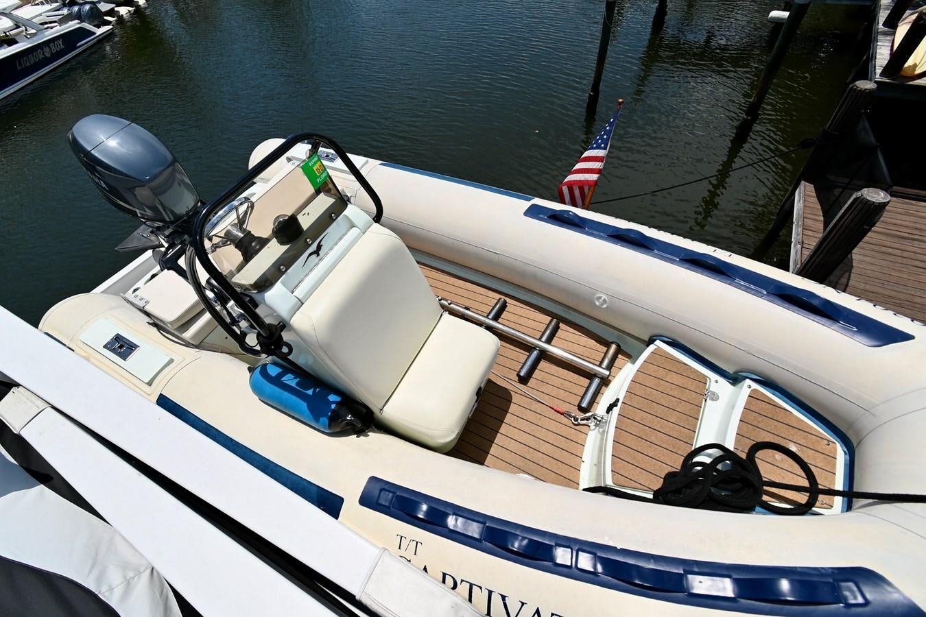 a boat with a steering wheel and a sail on the water aboard CAPTIVATOR Yacht for Sale