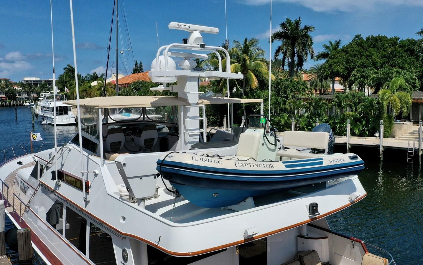 a boat docked at a pier aboard CAPTIVATOR Yacht for Sale