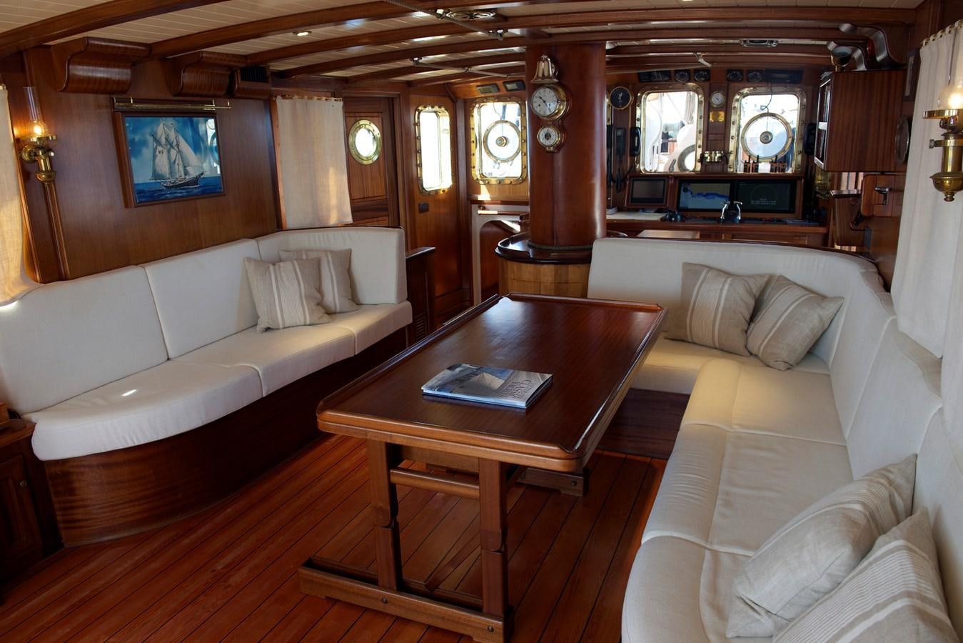 a living room with a table and couches aboard NO.6 TEXEL Yacht for Sale