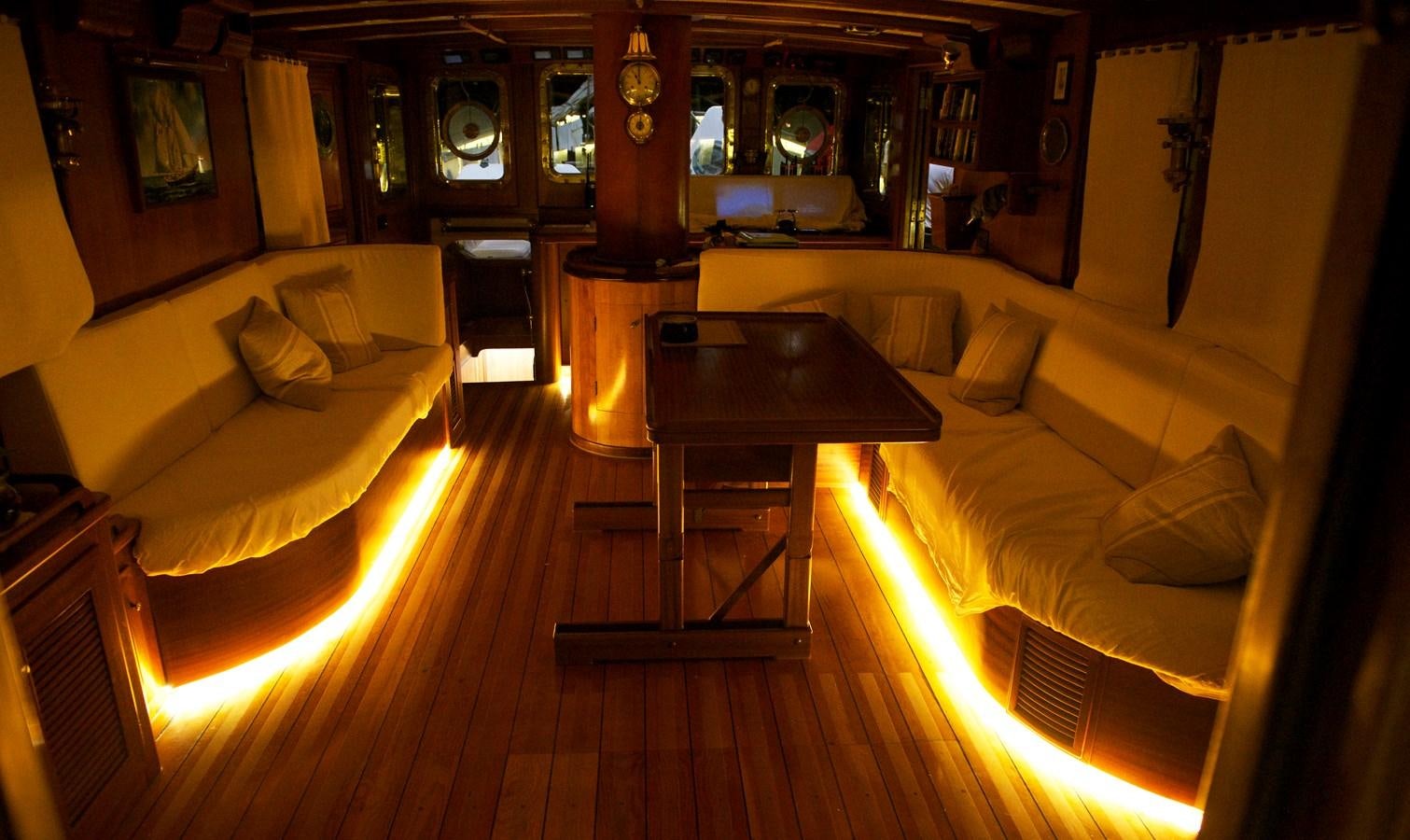 a room with a table and couch aboard NO.6 TEXEL Yacht for Sale