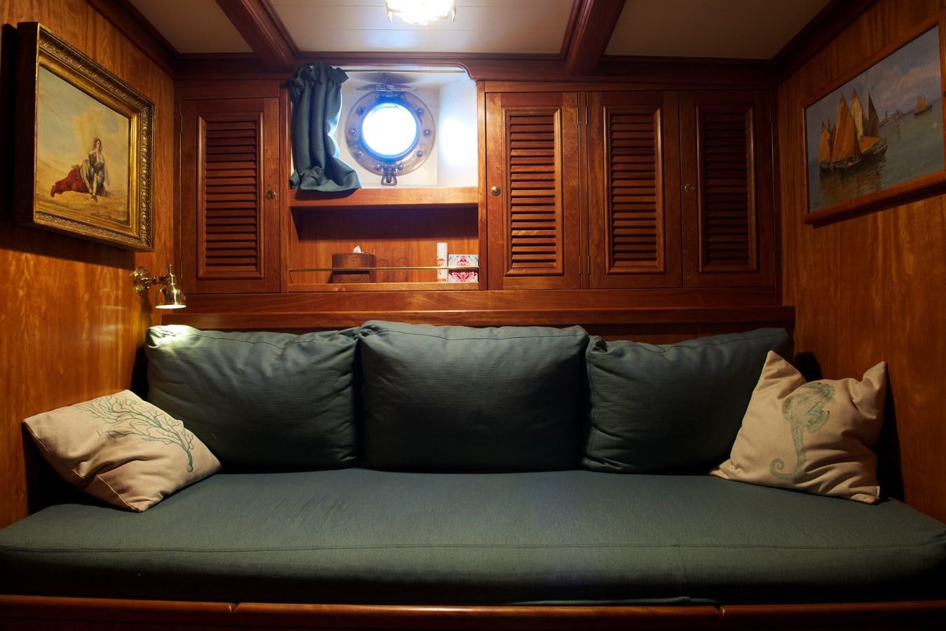 a couch with a mirror above it aboard NO.6 TEXEL Yacht for Sale