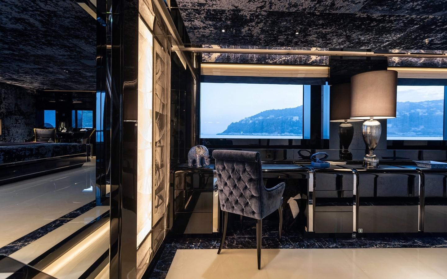 a room with a table and a tv aboard SARASTAR Yacht for Sale