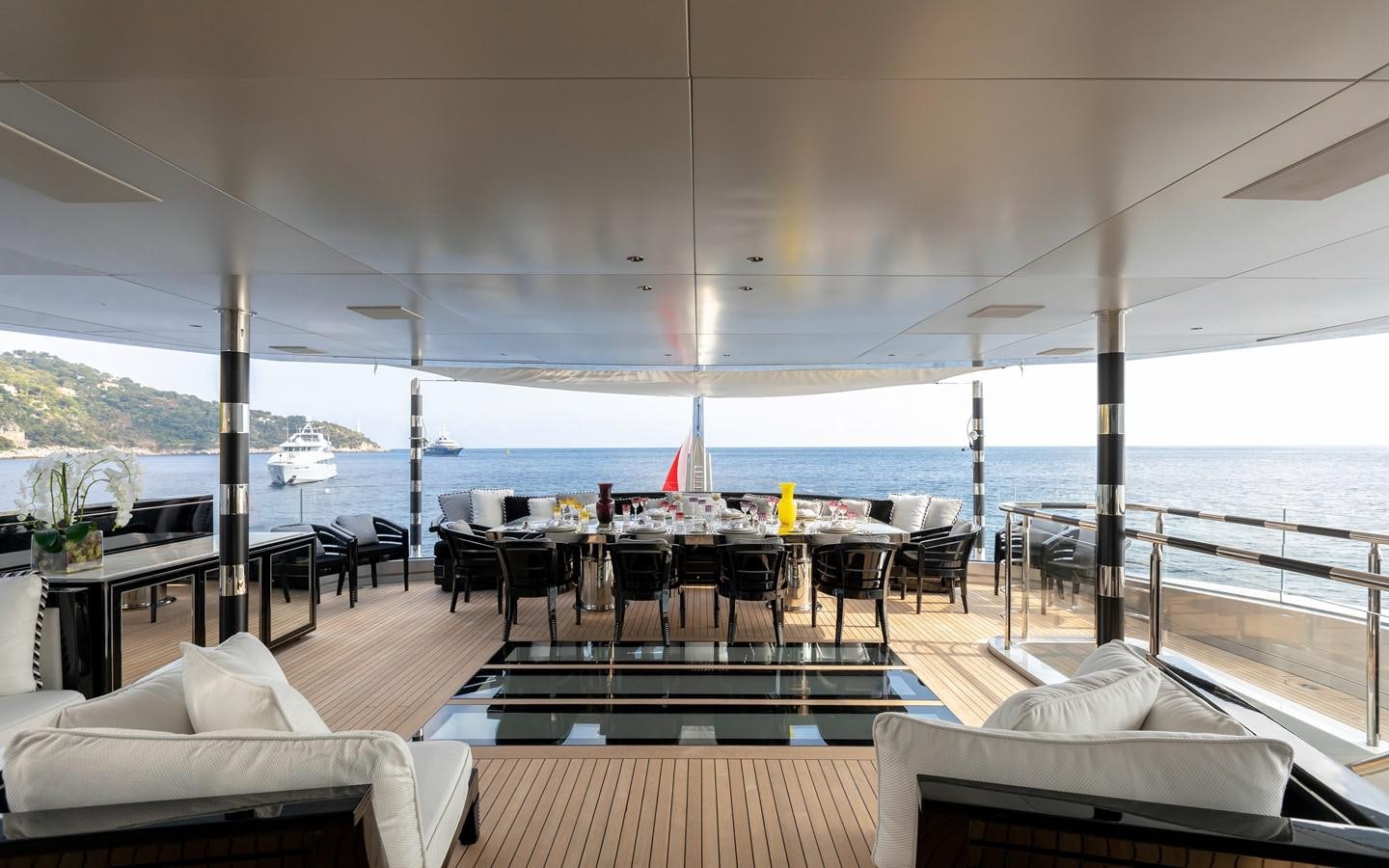 a room with a table and chairs aboard SARASTAR Yacht for Sale
