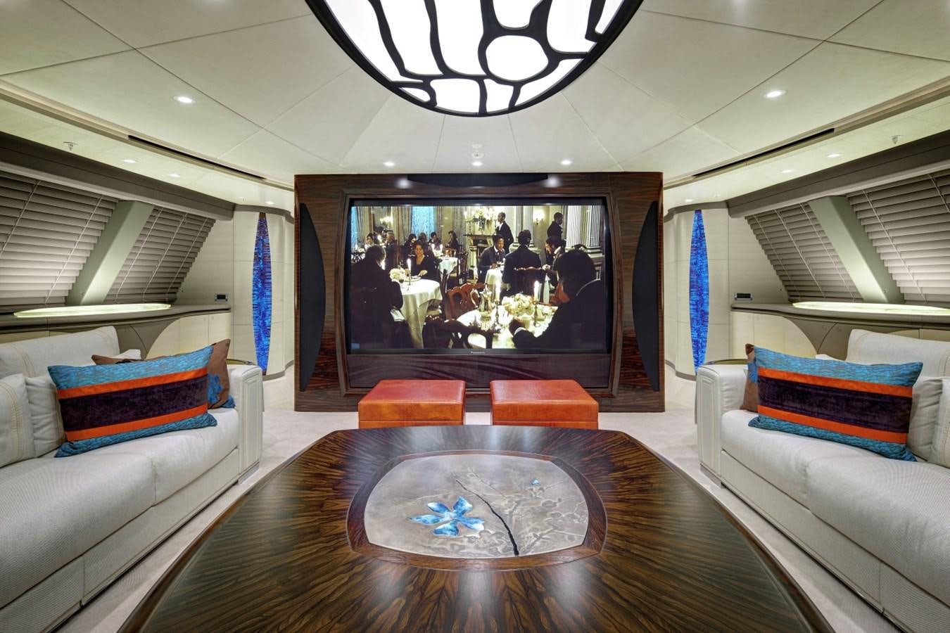 a living room with a large screen aboard SALVAJE Yacht for Charter