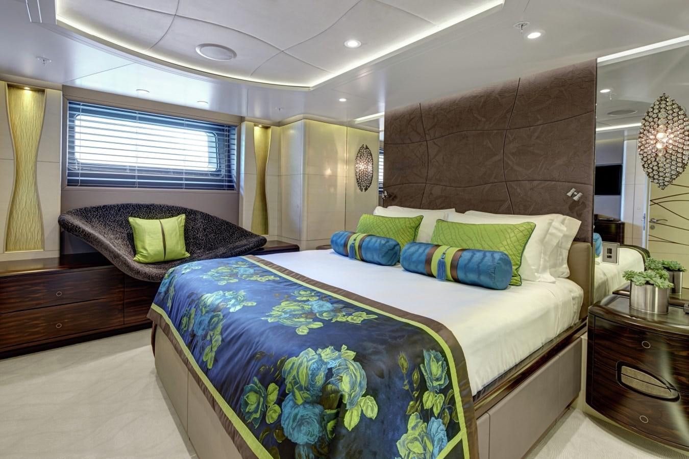 a bedroom with a bed and a window aboard SALVAJE Yacht for Charter